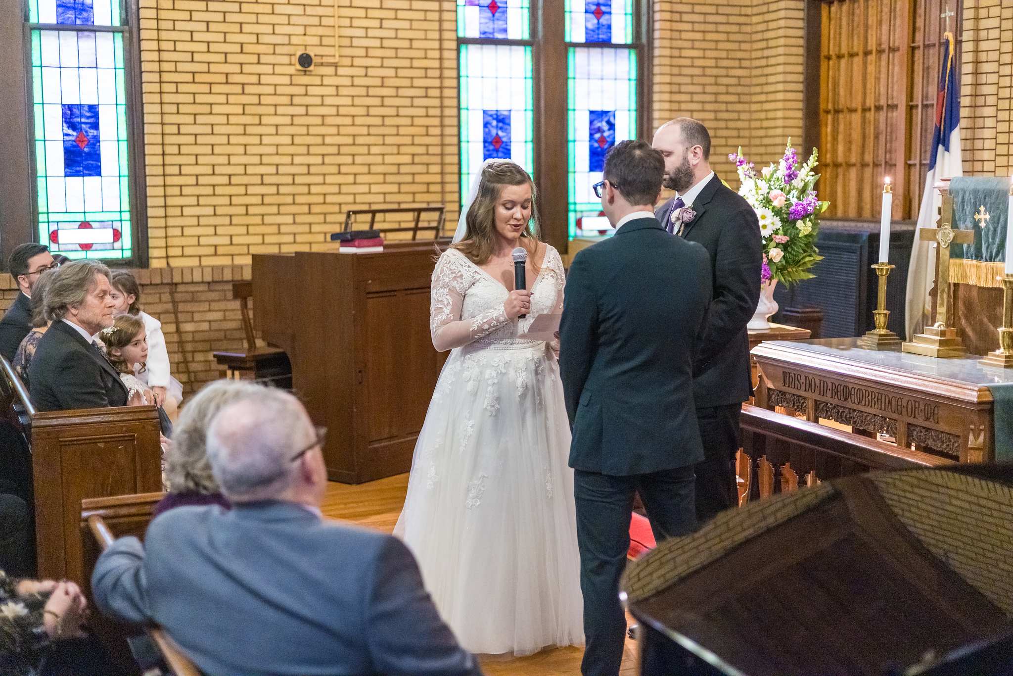 Couple exchanging vows during a ceremony at Fayetteville First United Methodist Church