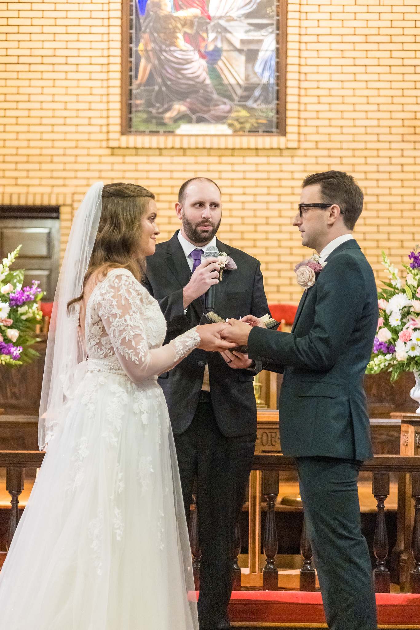 Bride placing a ring on the groom’s finger at Fayetteville First United Methodist Church