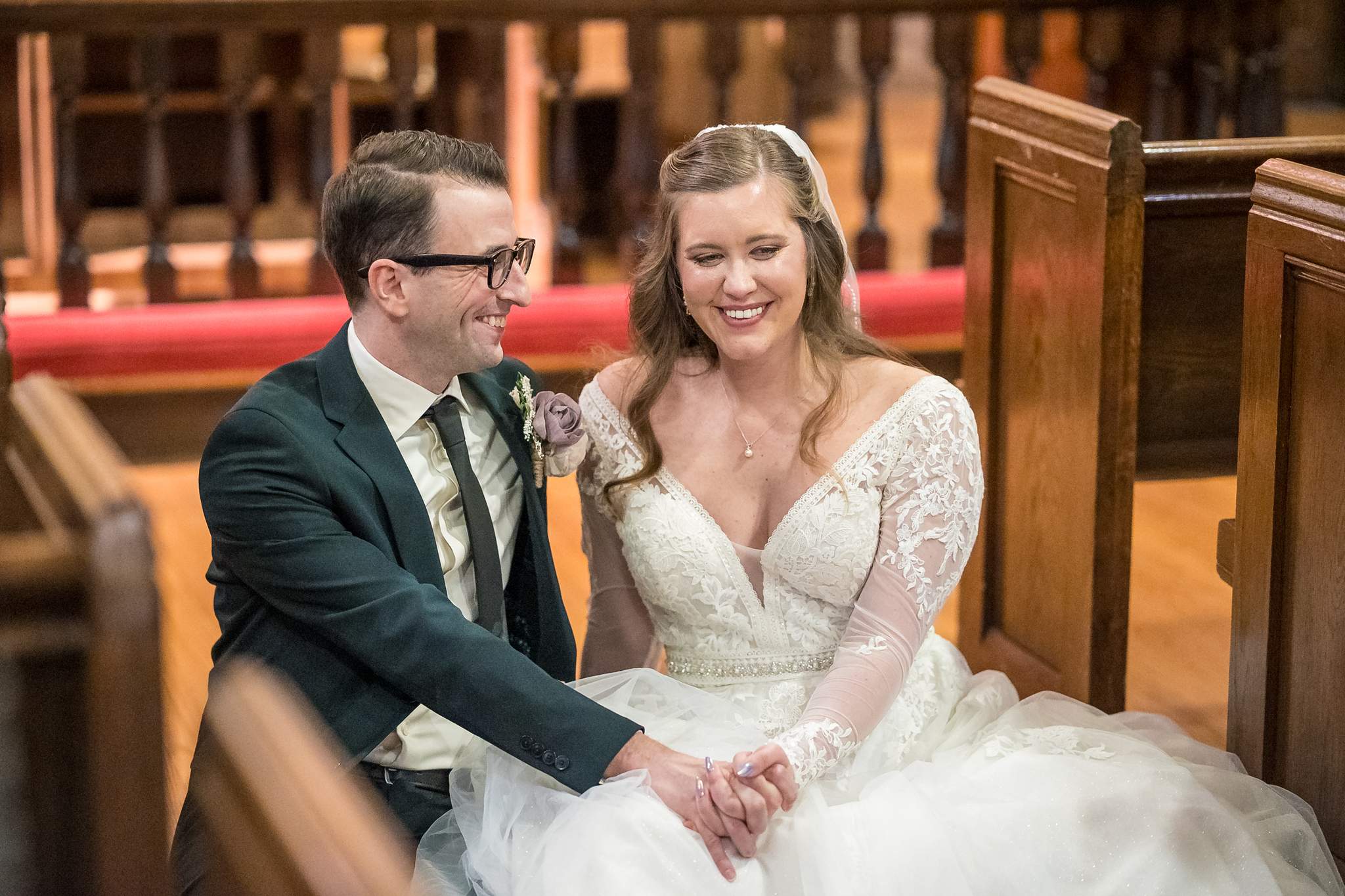 Close portrait of the couple sitting in a church pew