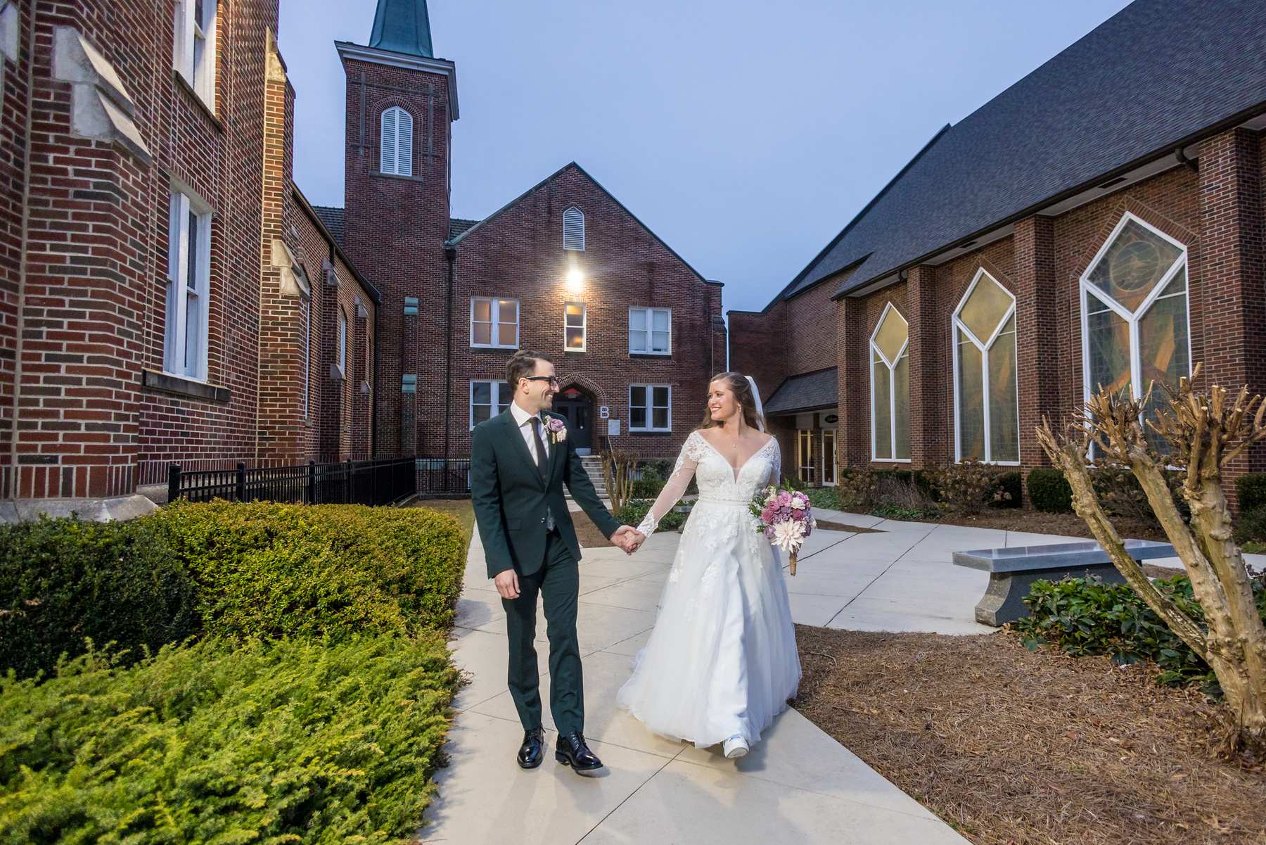Couple walking on the church grounds at Fayetteville First United Methodist Church at dusk