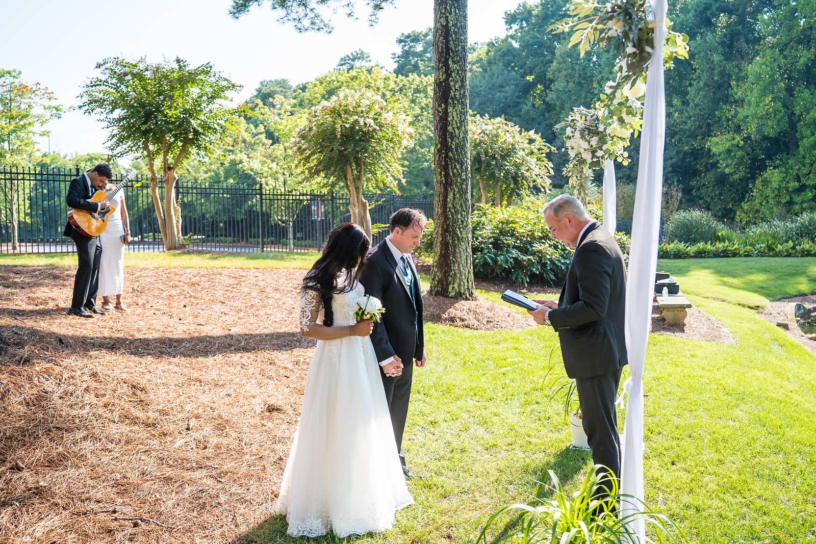 Small outdoor wedding ceremony with a guitarist on the lawn at First Baptist Atlanta