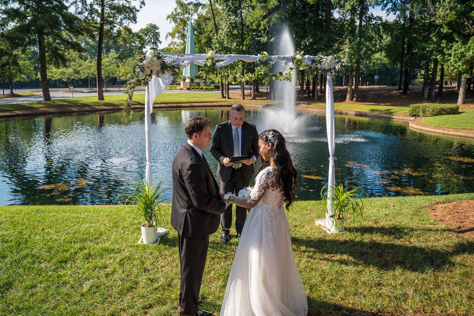Couple exchanging rings beside the fountain at First Baptist Atlanta