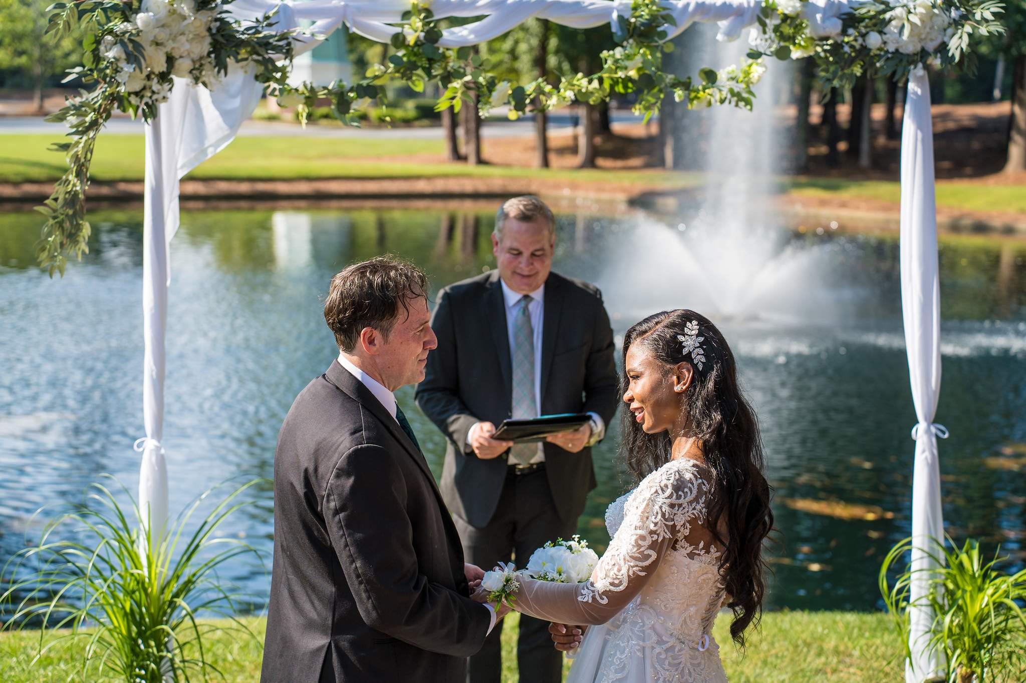 Officiant reading during a lakeside wedding ceremony