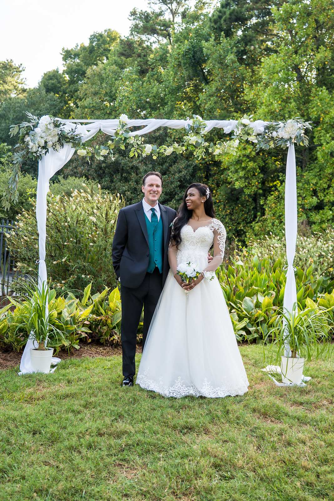Couple portrait under the floral arch at First Baptist Atlanta