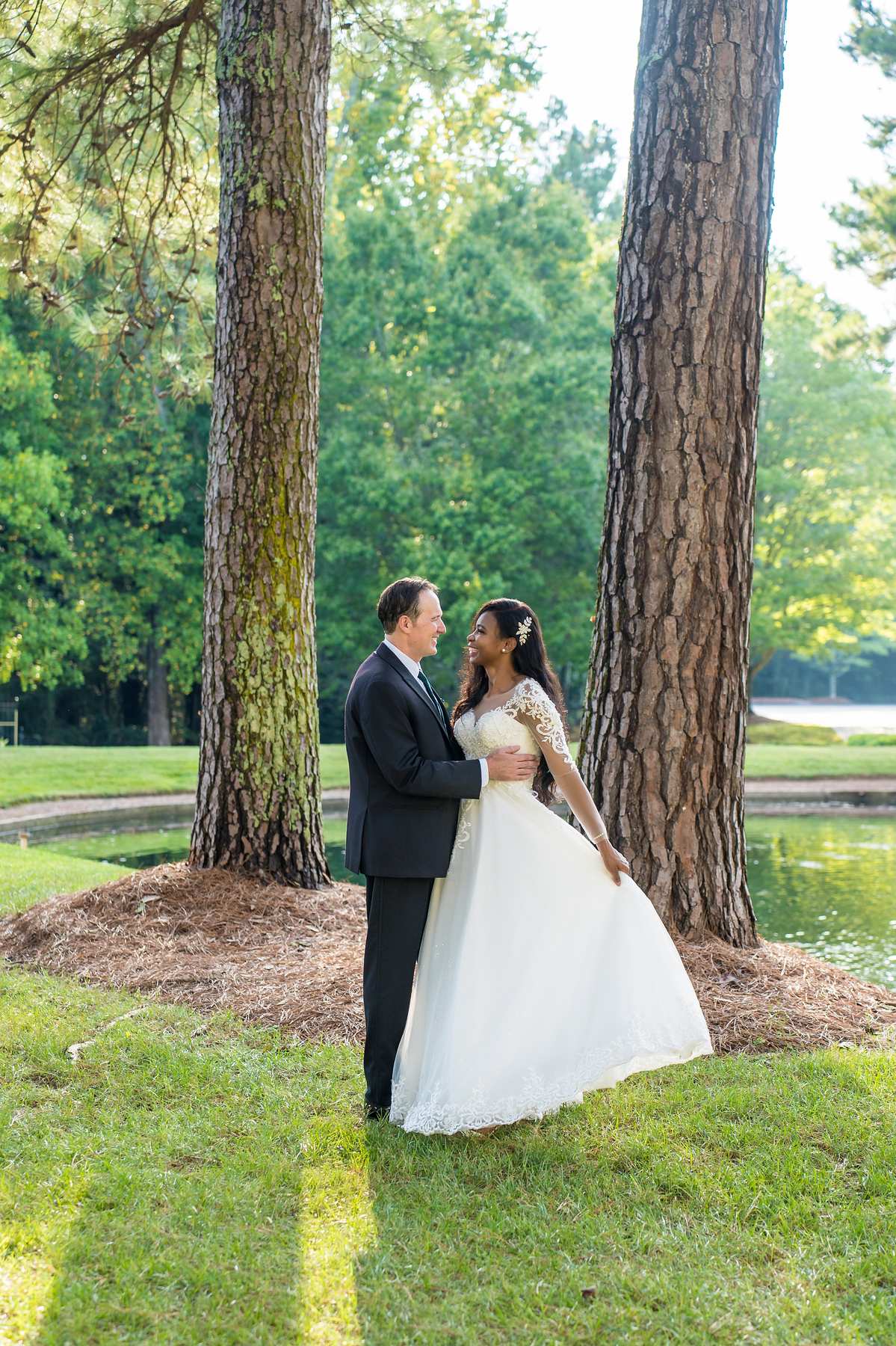 Couple holding each other by the pine trees at First Baptist Atlanta