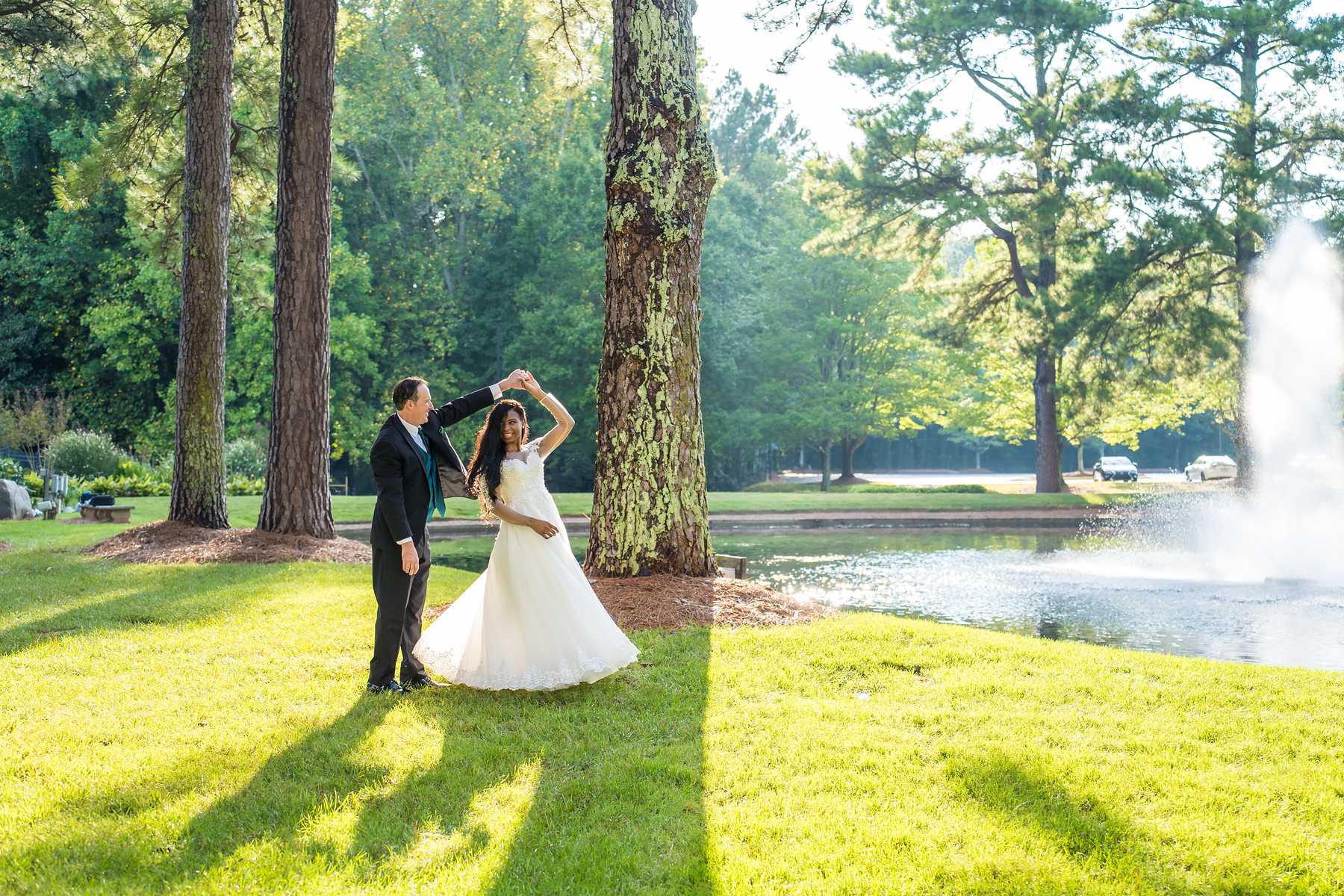 Couple twirling on the sunny lawn at First Baptist Atlanta