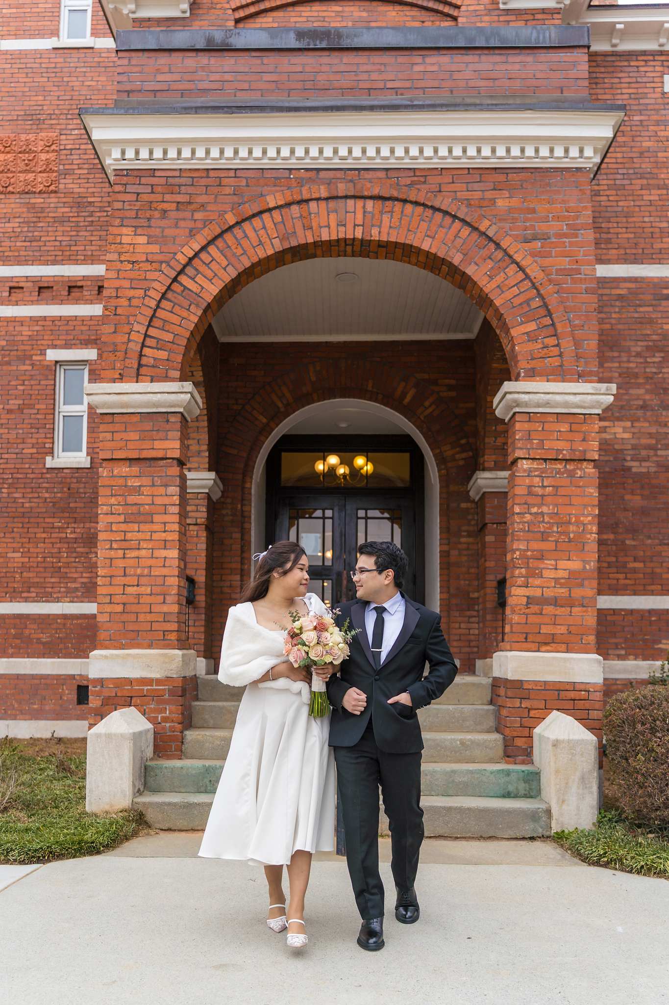 Couple walking down the front steps of the Gwinnett Historic Courthouse