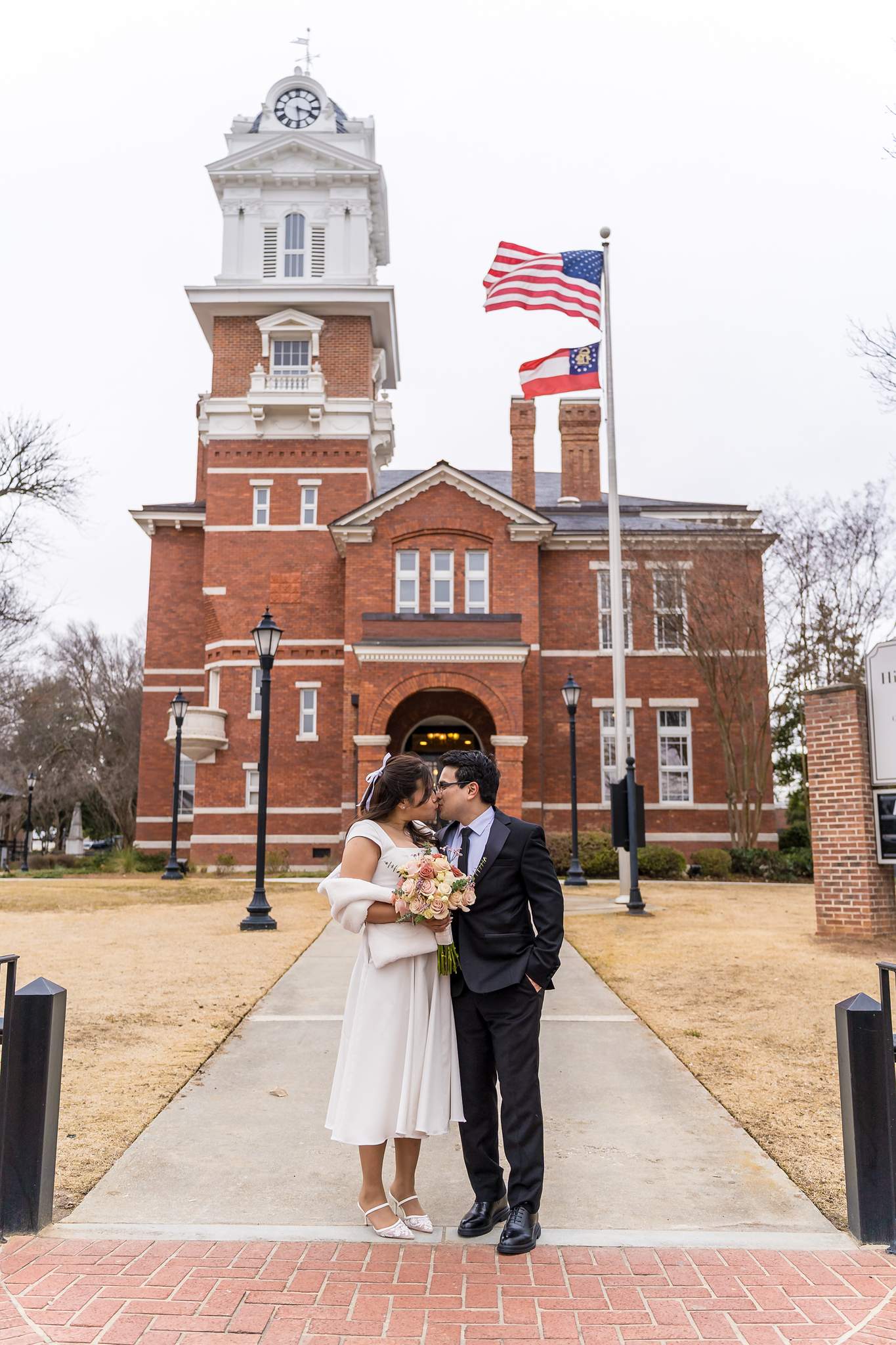 Couple on the brick walkway in front of the Gwinnett Historic Courthouse
