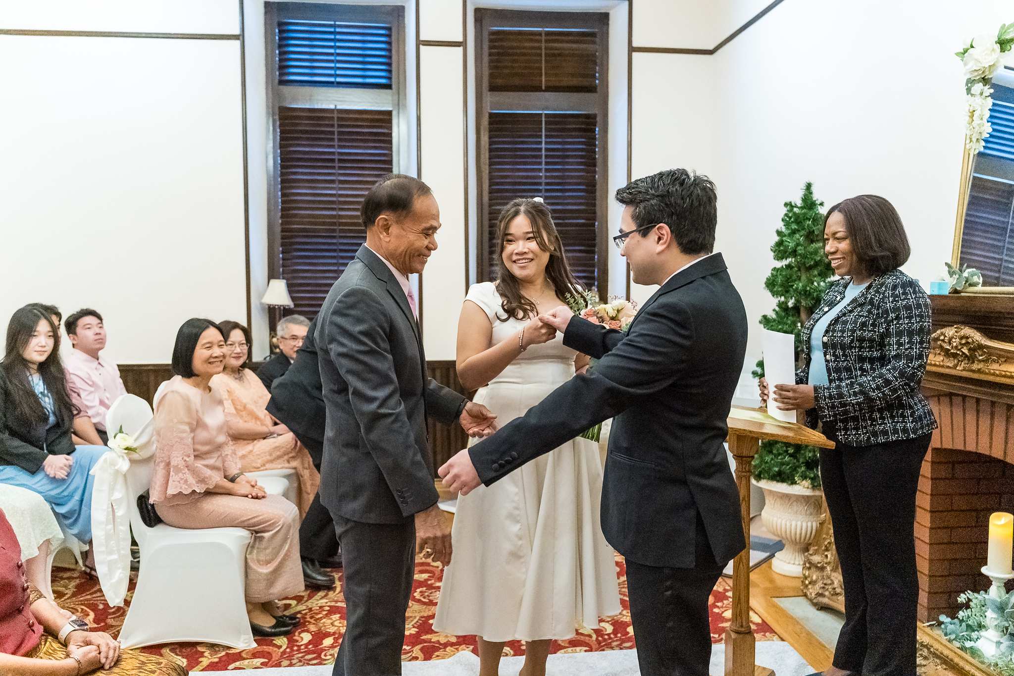 Couple exchanging rings during a ceremony at the Gwinnett Historic Courthouse