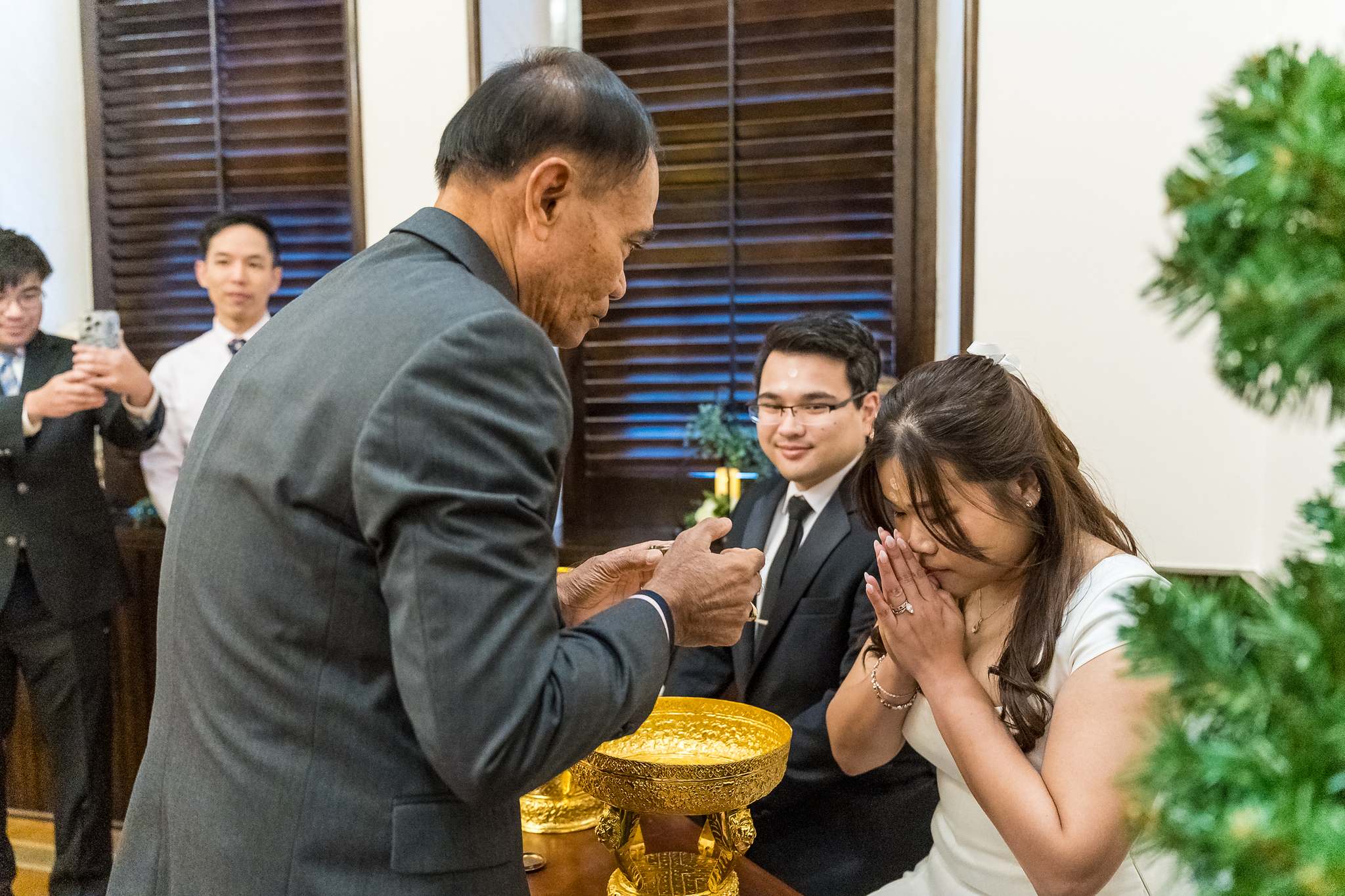 Bride smiling during a family water blessing at her elopement