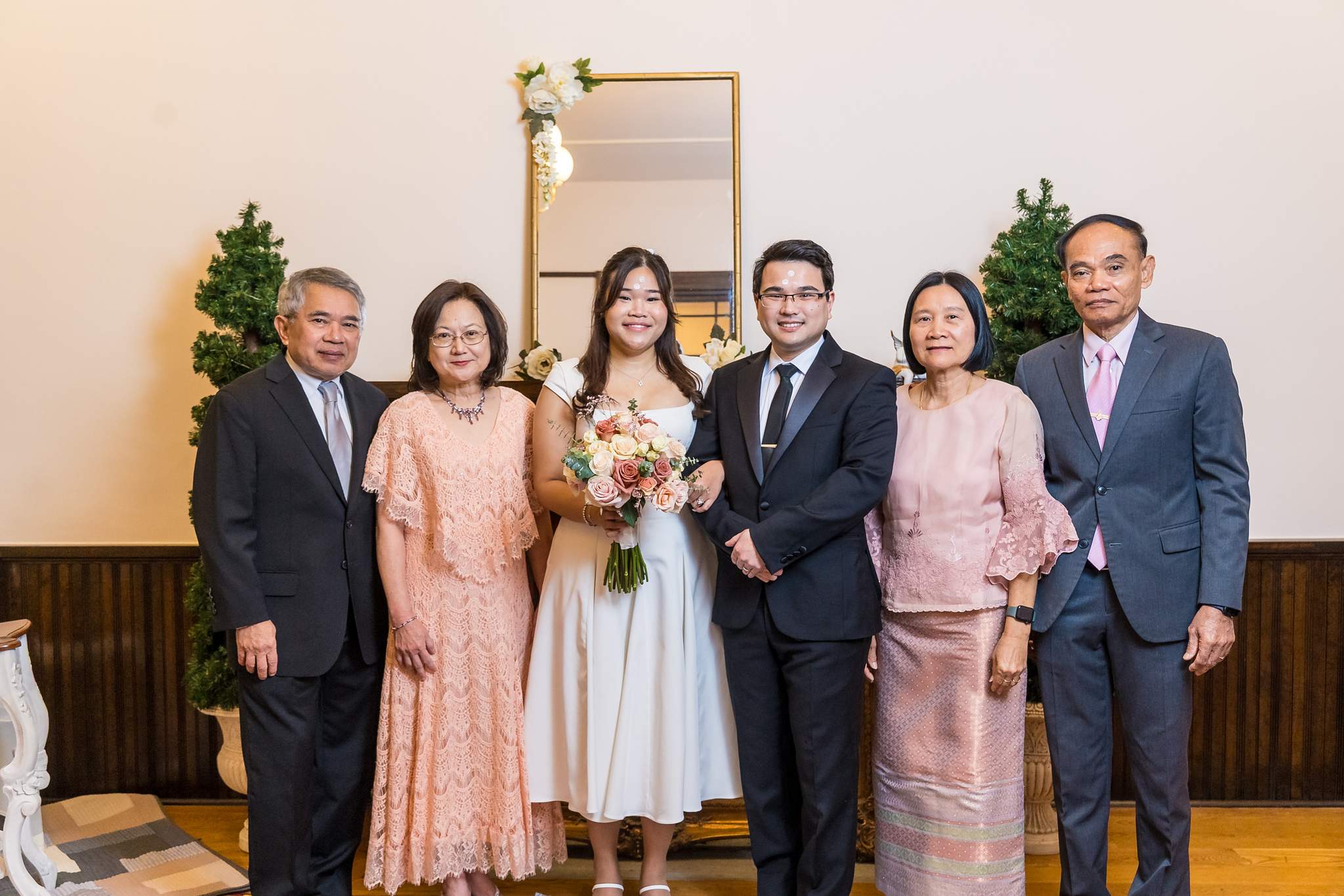 Extended family portrait with the couple inside a historic courthouse