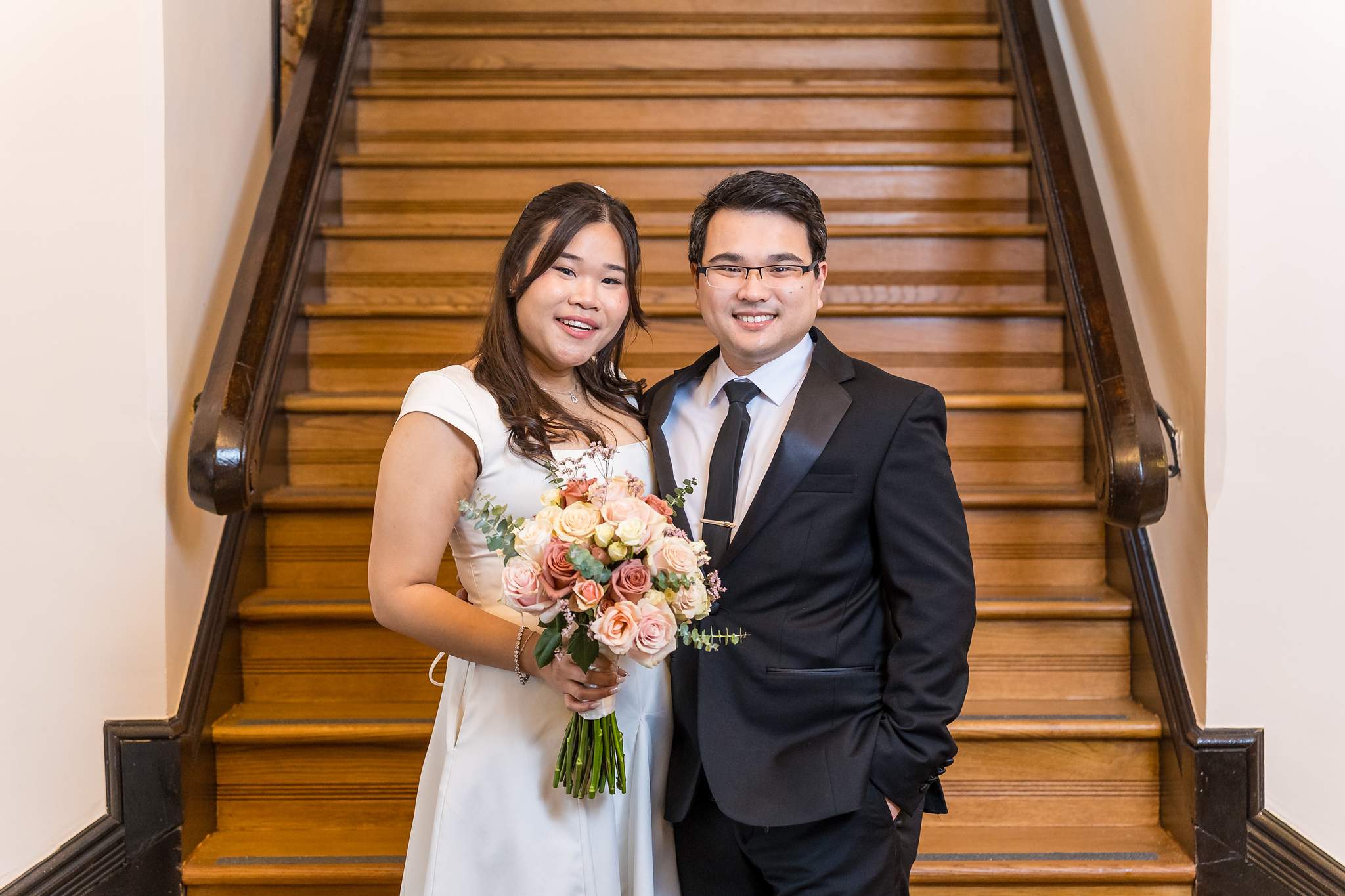 Couple portrait on the wooden staircase inside the Gwinnett Historic Courthouse