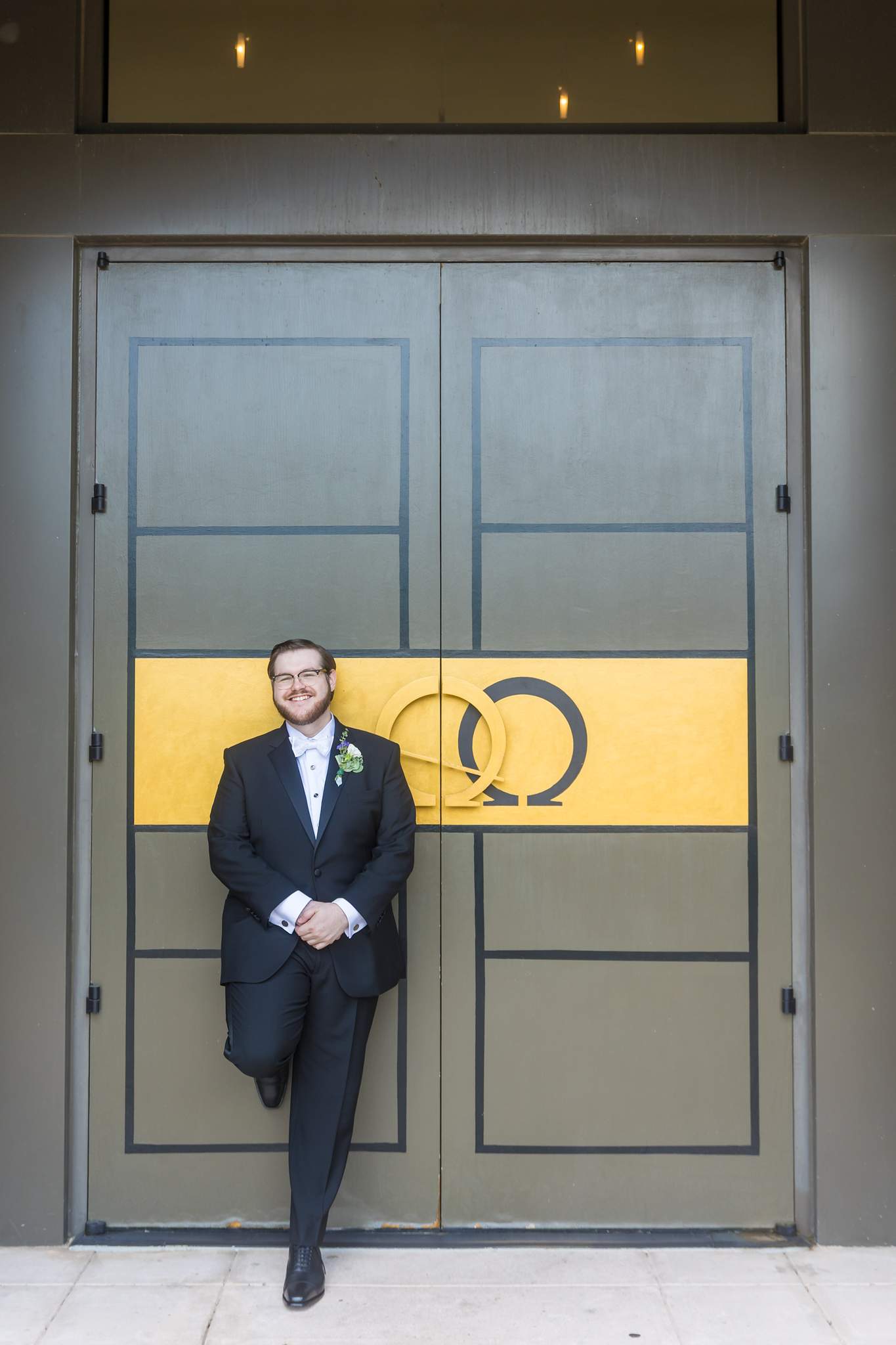 Groom portrait at the gold-paneled church doors of Immaculate Heart of Mary