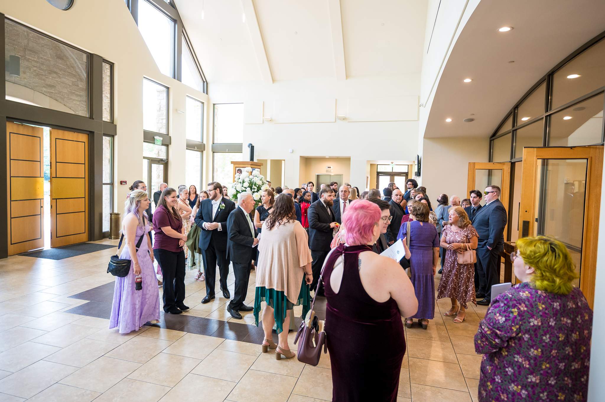 Guests gathering in the church lobby before a wedding at Immaculate Heart of Mary