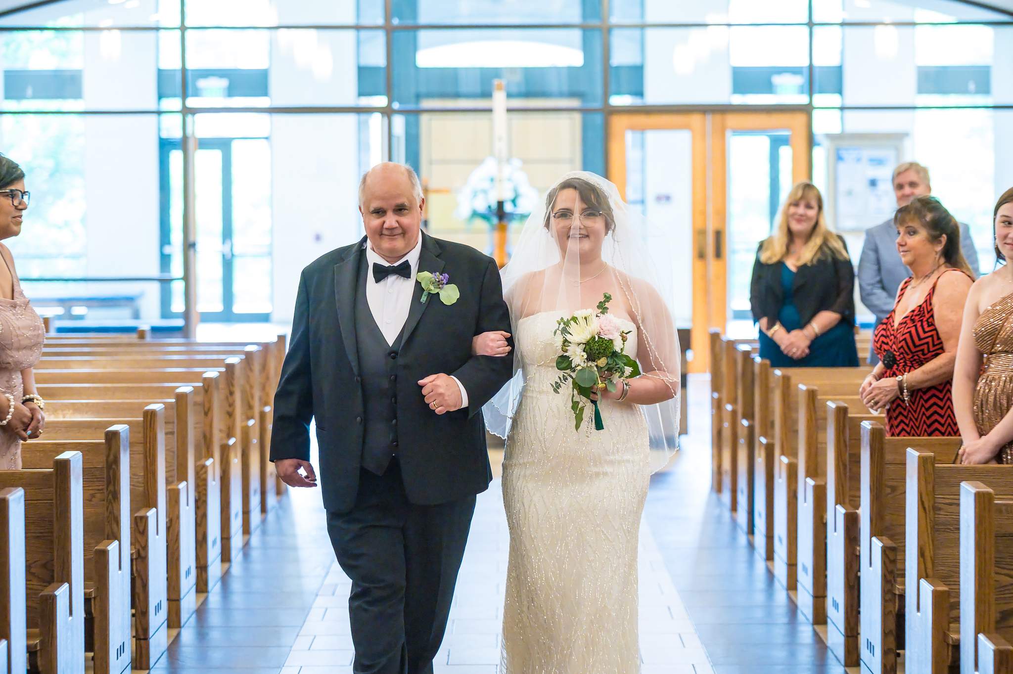 Bride being escorted down the aisle at Immaculate Heart of Mary