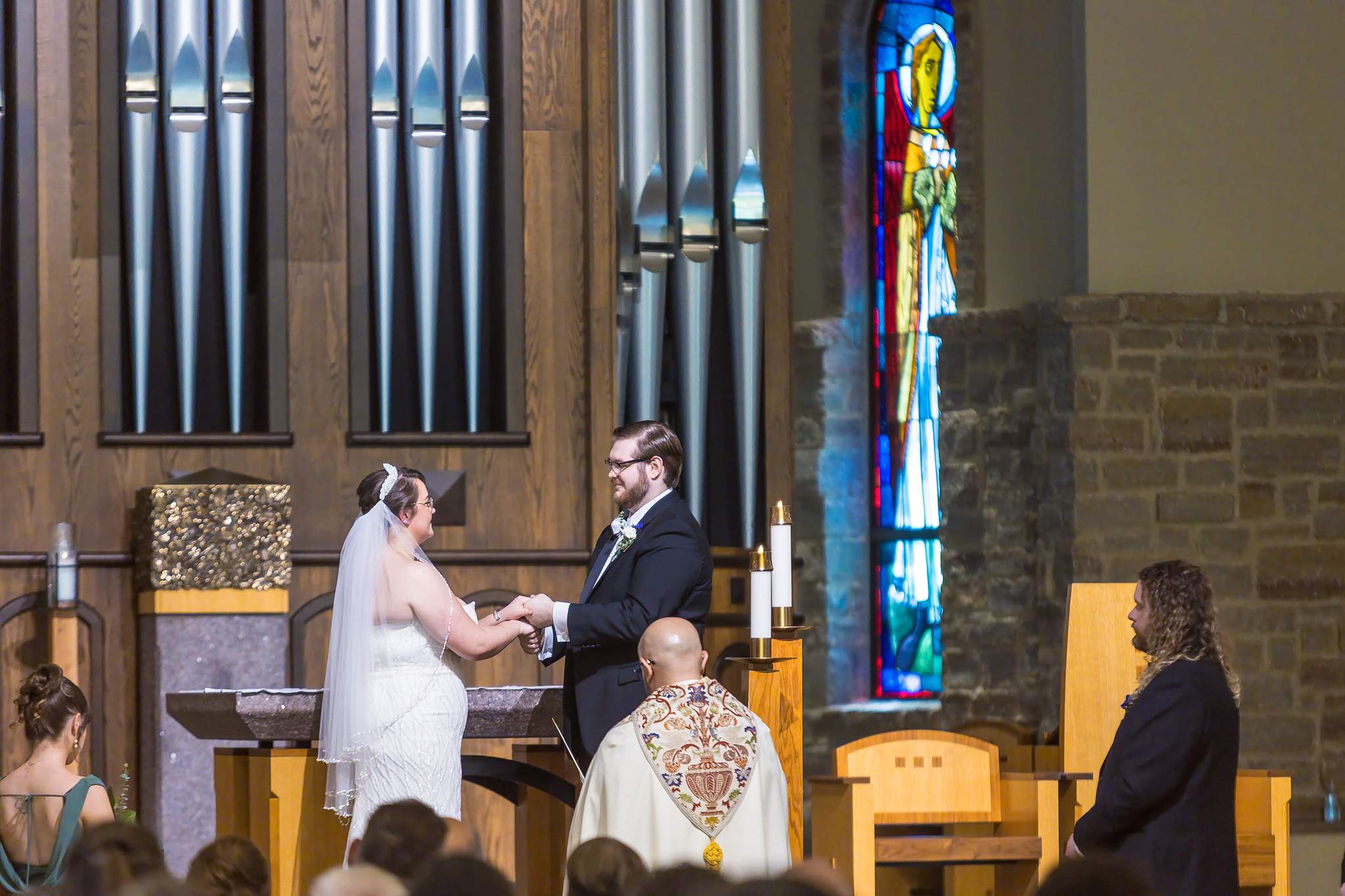Ring exchange in front of the organ pipes and stained glass at Immaculate Heart of Mary