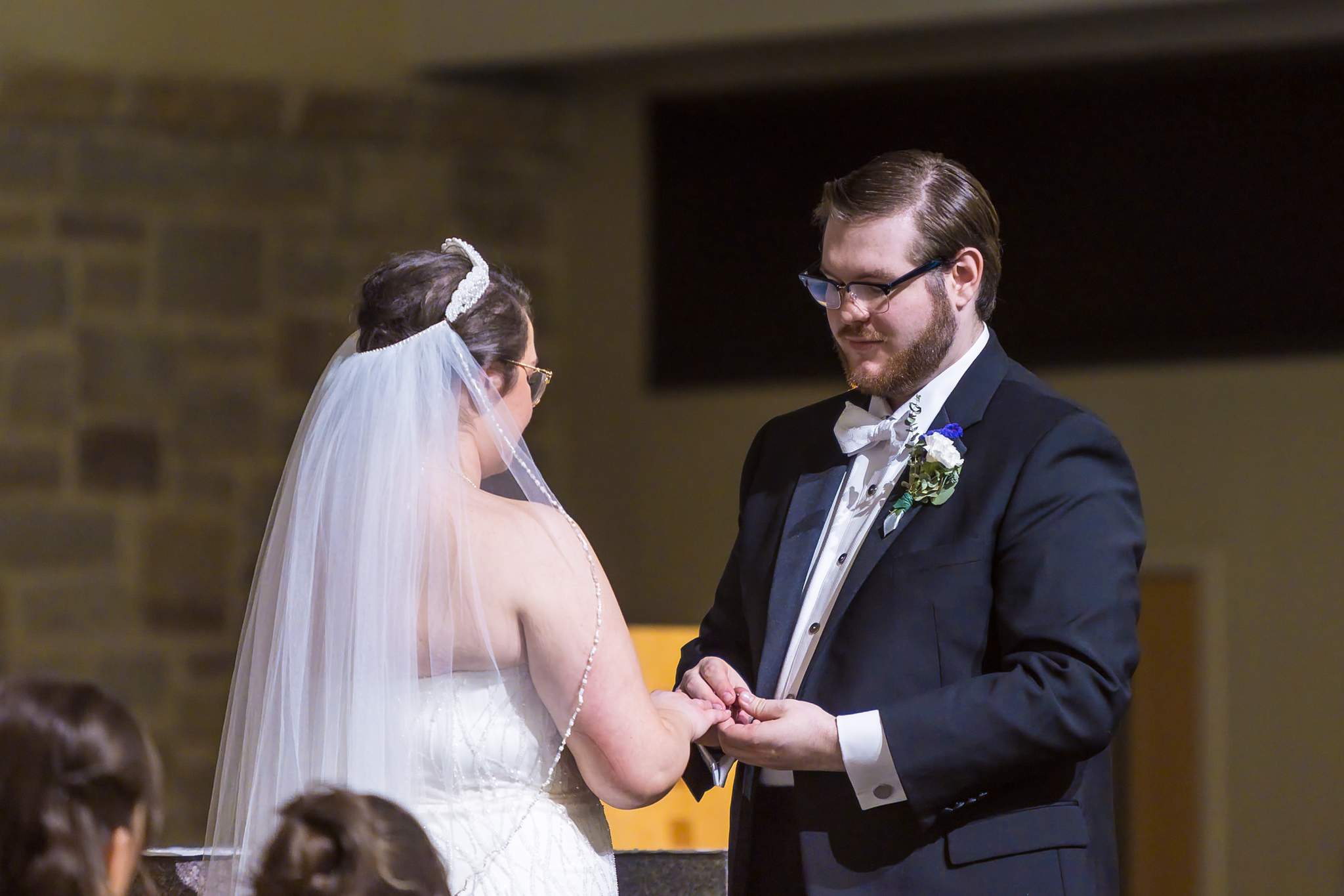 Groom placing the ring on the bride's finger at Immaculate Heart of Mary