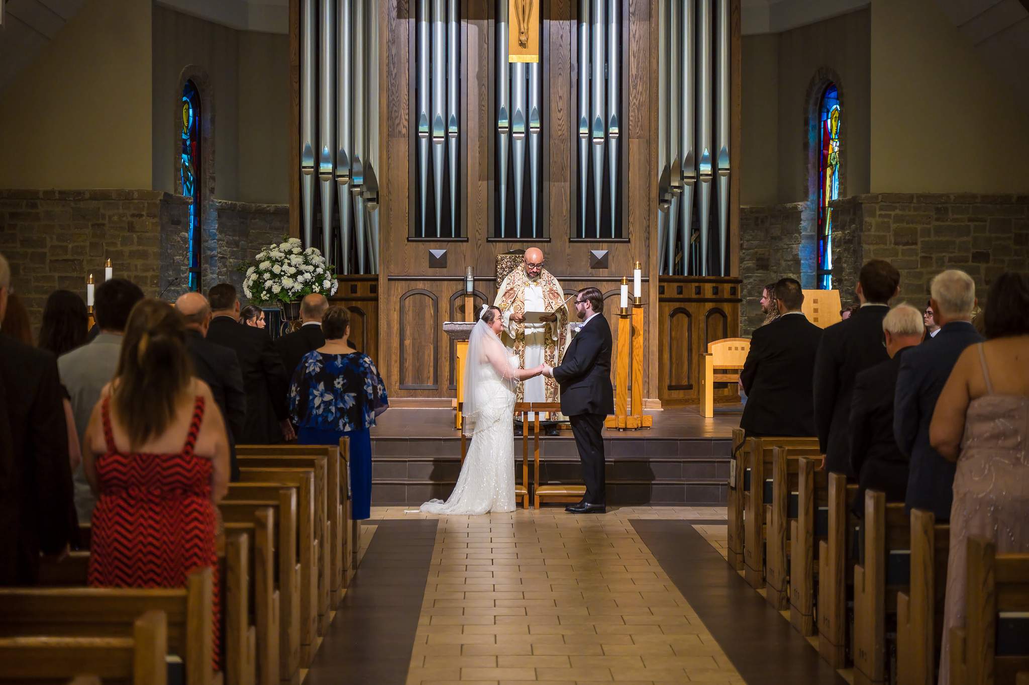 View down the aisle during a Catholic wedding ceremony at Immaculate Heart of Mary