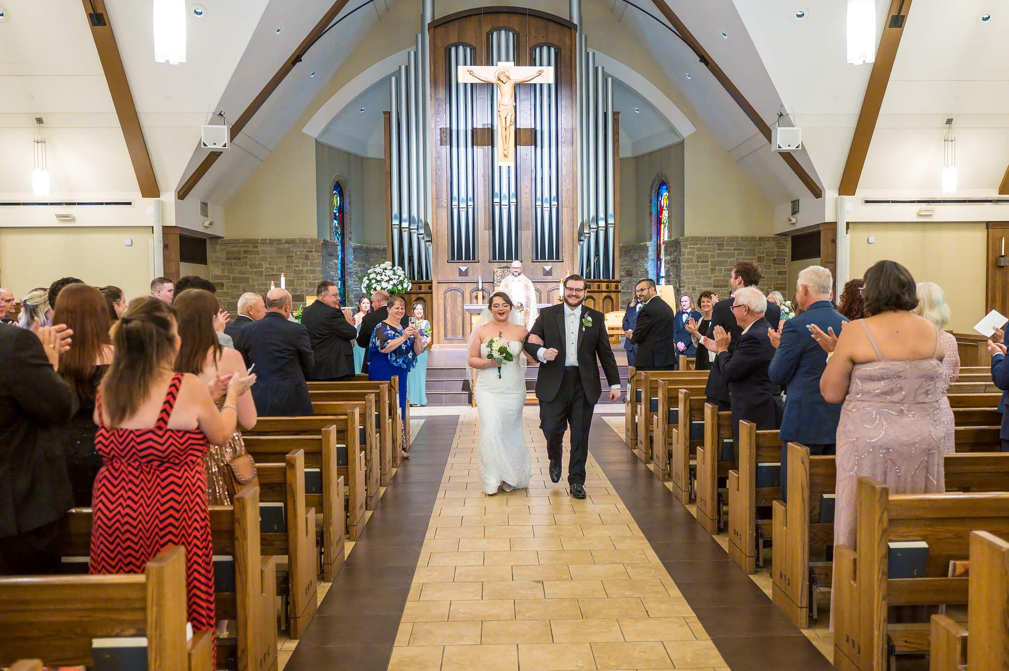 Couple walking back up the aisle after their ceremony at Immaculate Heart of Mary in Atlanta