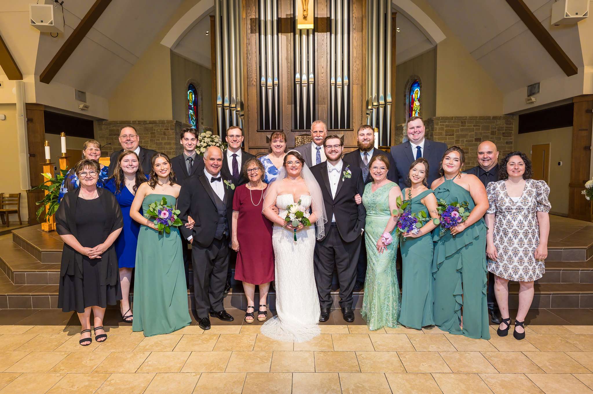 Family and wedding party portrait in the sanctuary at Immaculate Heart of Mary
