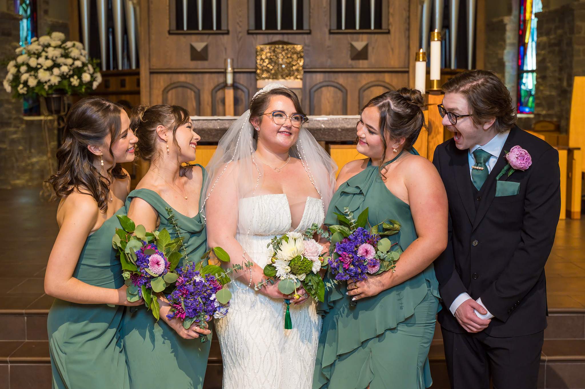 Bride and groom with bridesmaids at the altar of Immaculate Heart of Mary