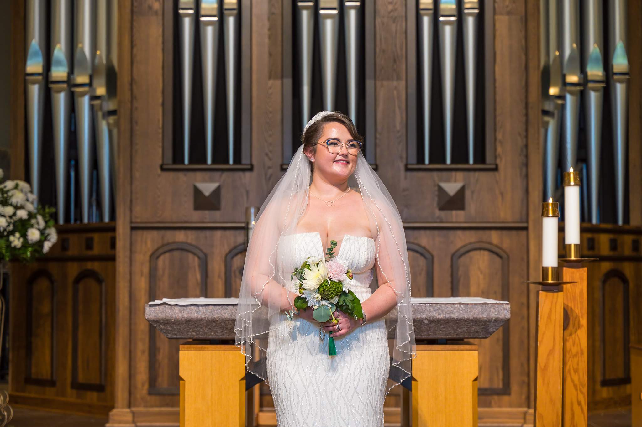 Bridal portrait in front of the altar and organ pipes at Immaculate Heart of Mary