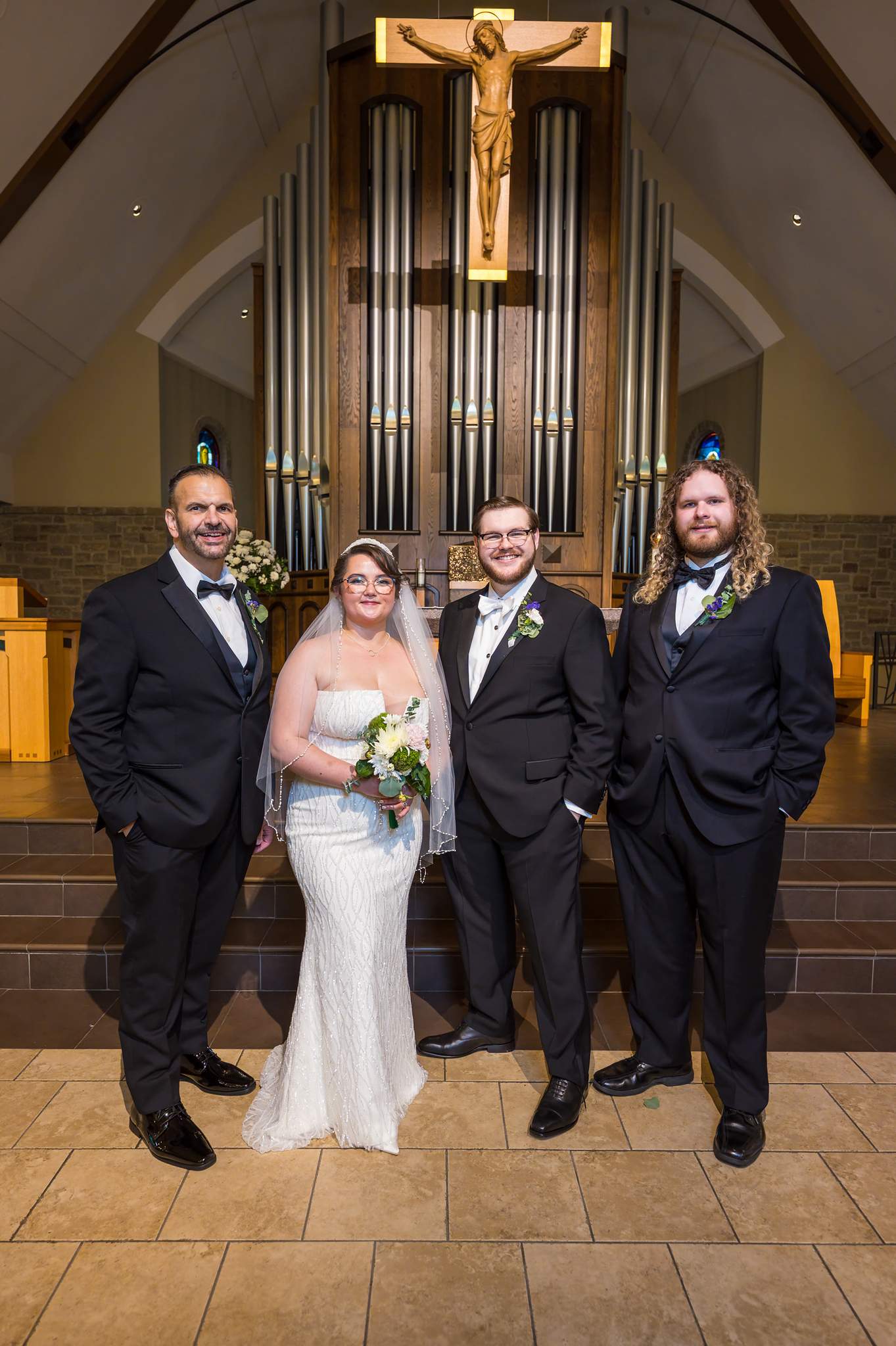 Couple with groomsmen in the sanctuary at Immaculate Heart of Mary