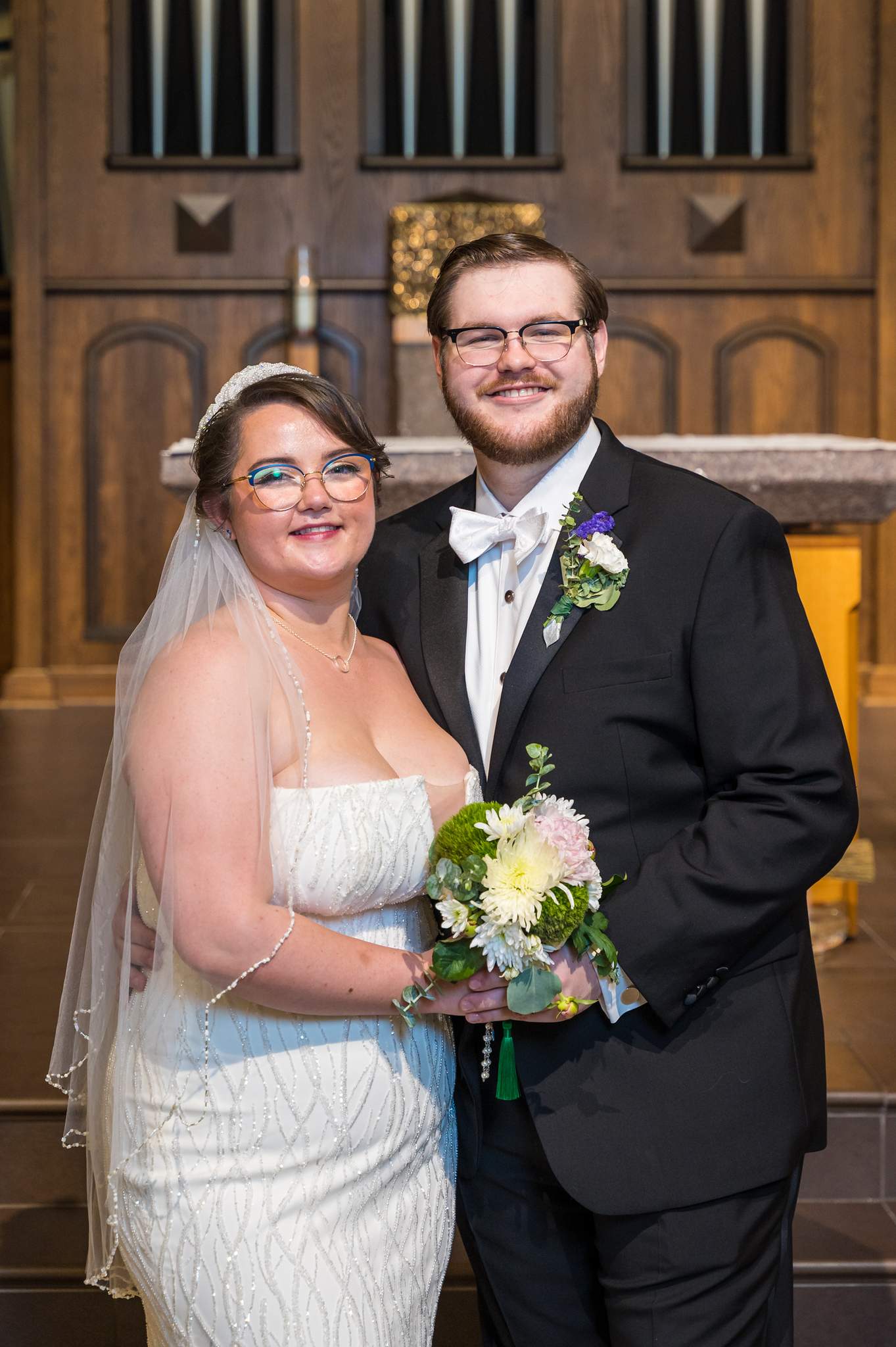 Bride and groom portrait in front of the altar at Immaculate Heart of Mary