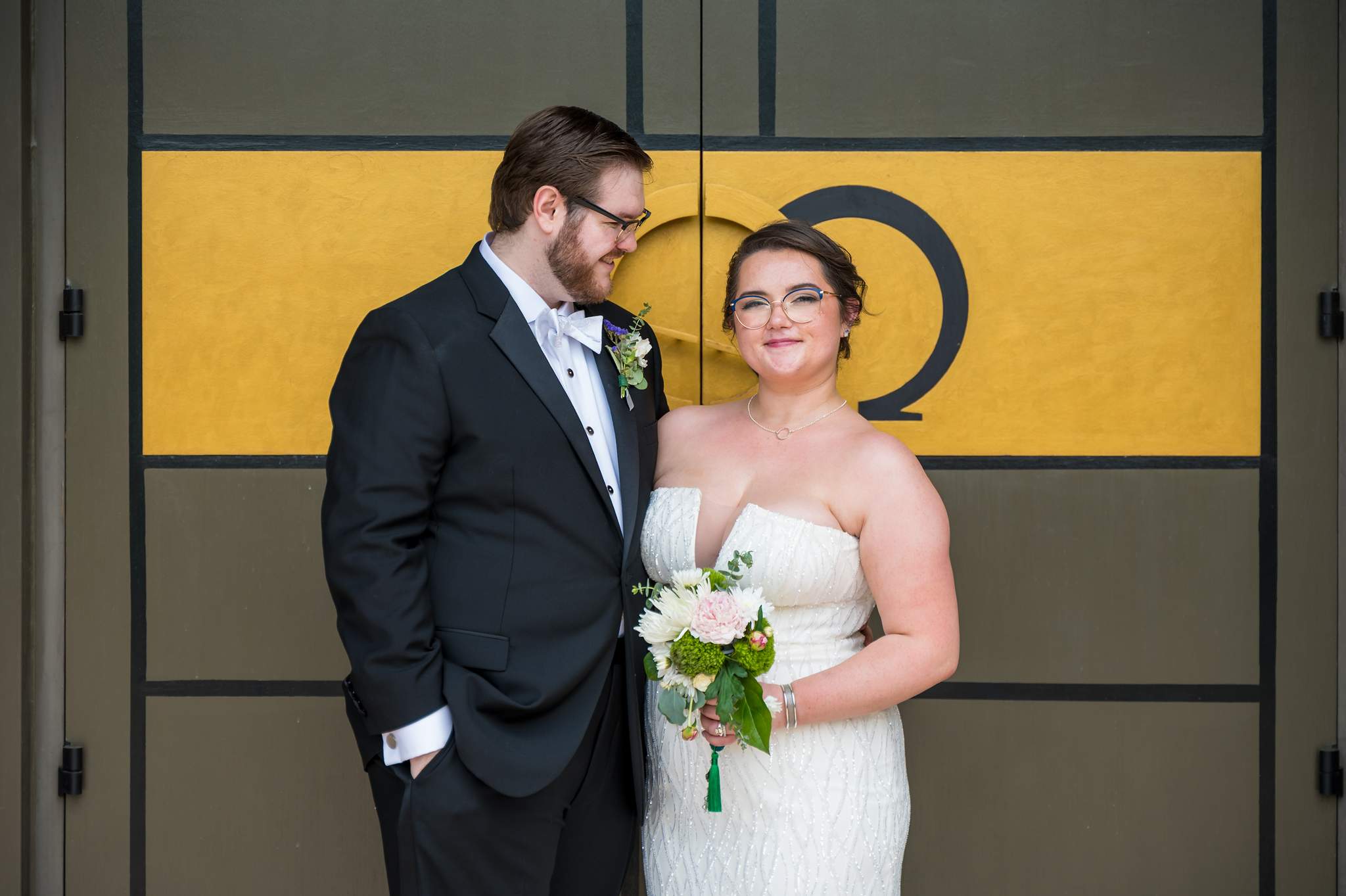 Couple portrait at the gold-paneled doors of Immaculate Heart of Mary in Atlanta