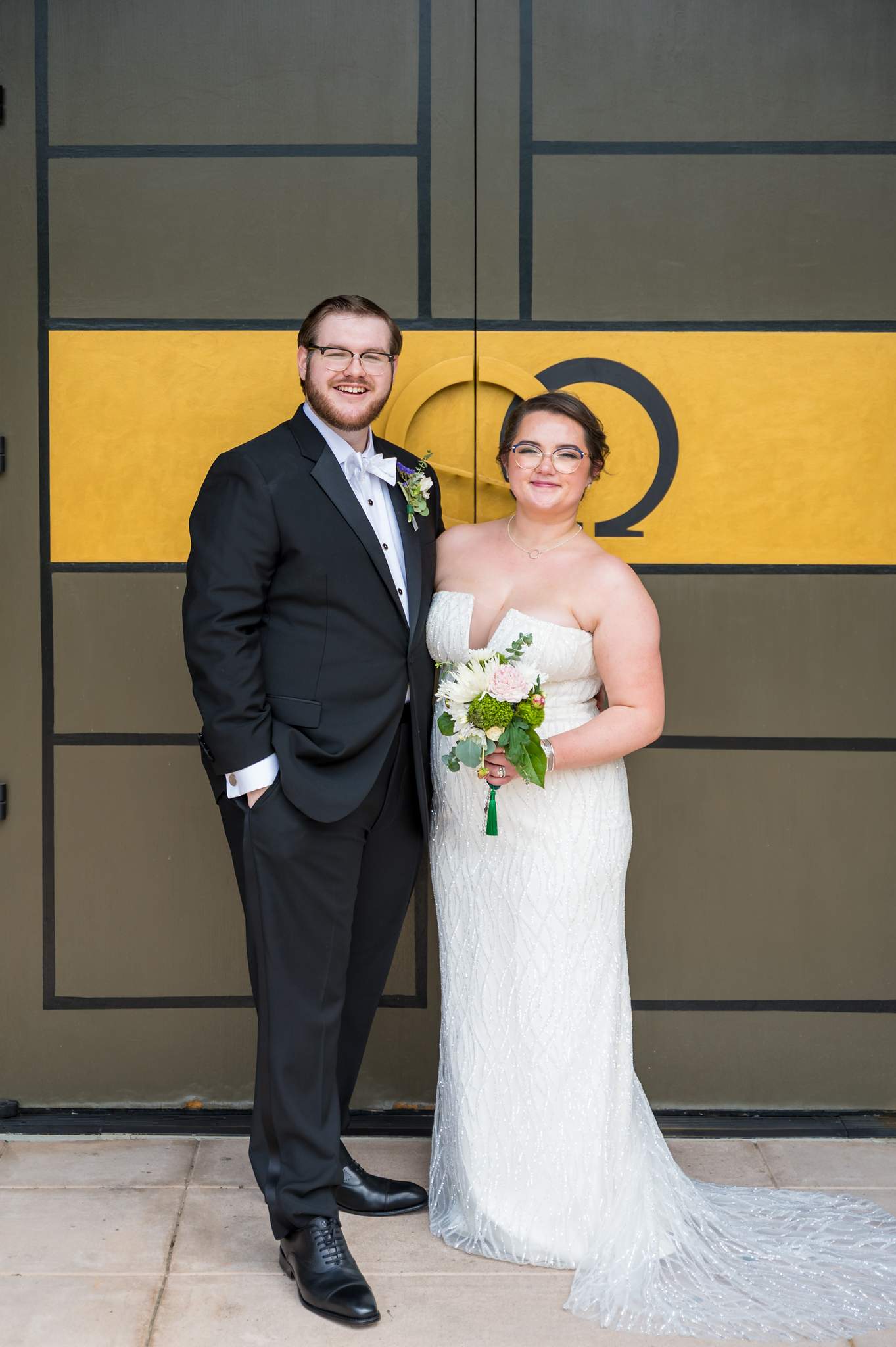 Bride and groom at the church entrance doors of Immaculate Heart of Mary