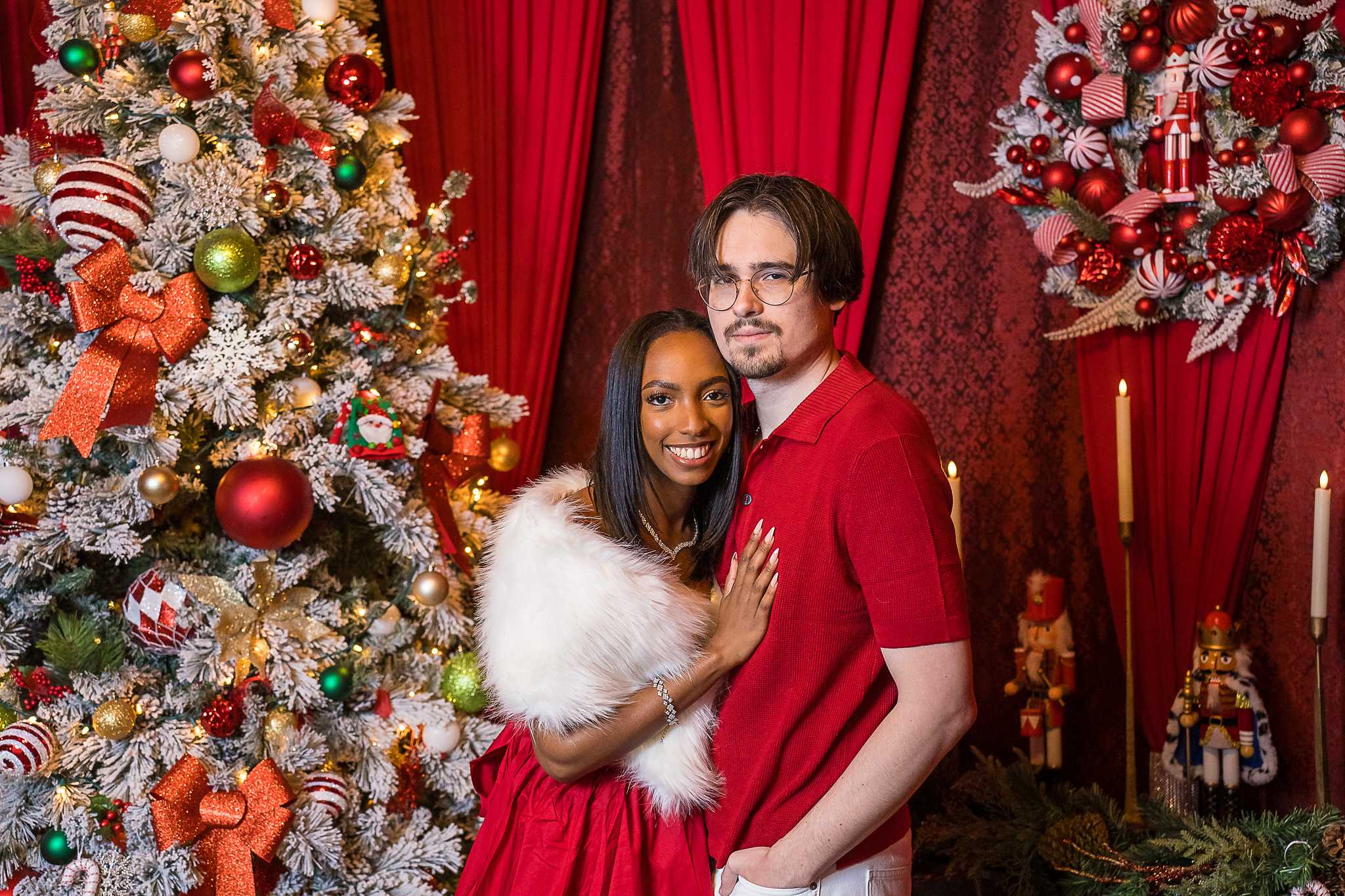 Couple embracing by a Christmas tree, an indoor photoshoot location in Atlanta