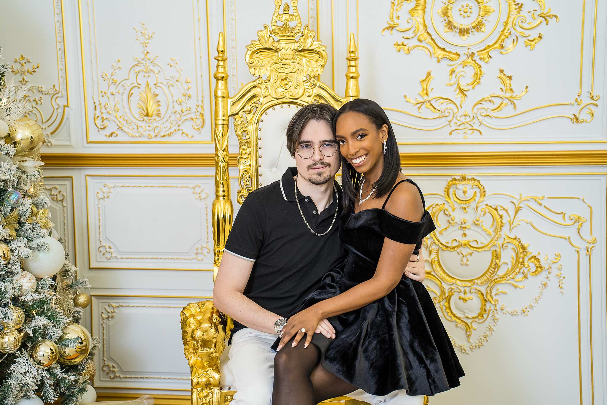 Couple on a gold throne chair in the white and gold Palace Set at Luxe Galore