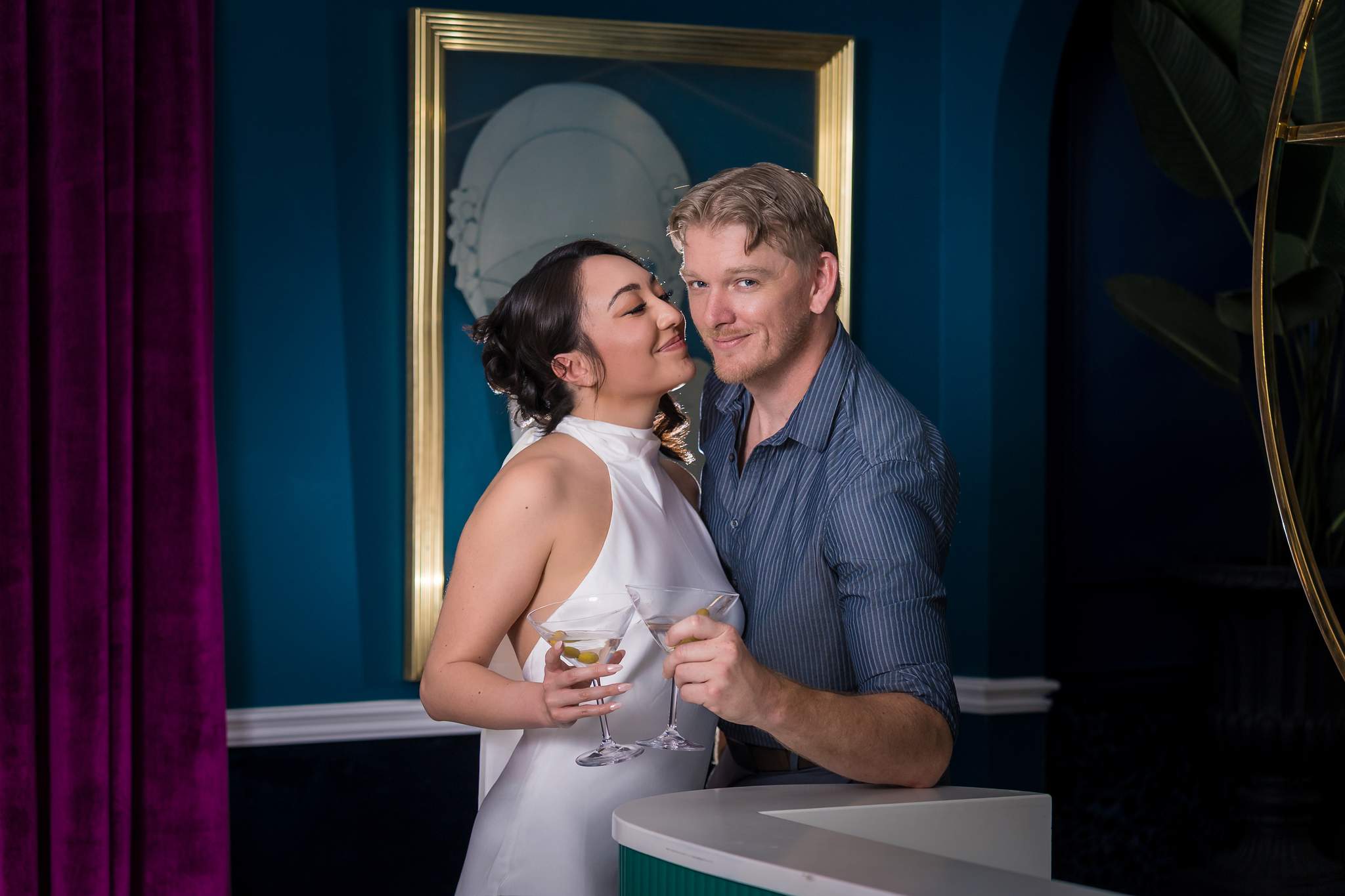 Couple laughing together at a bar with a gold mirror at Luxe Galore Studios Atlanta