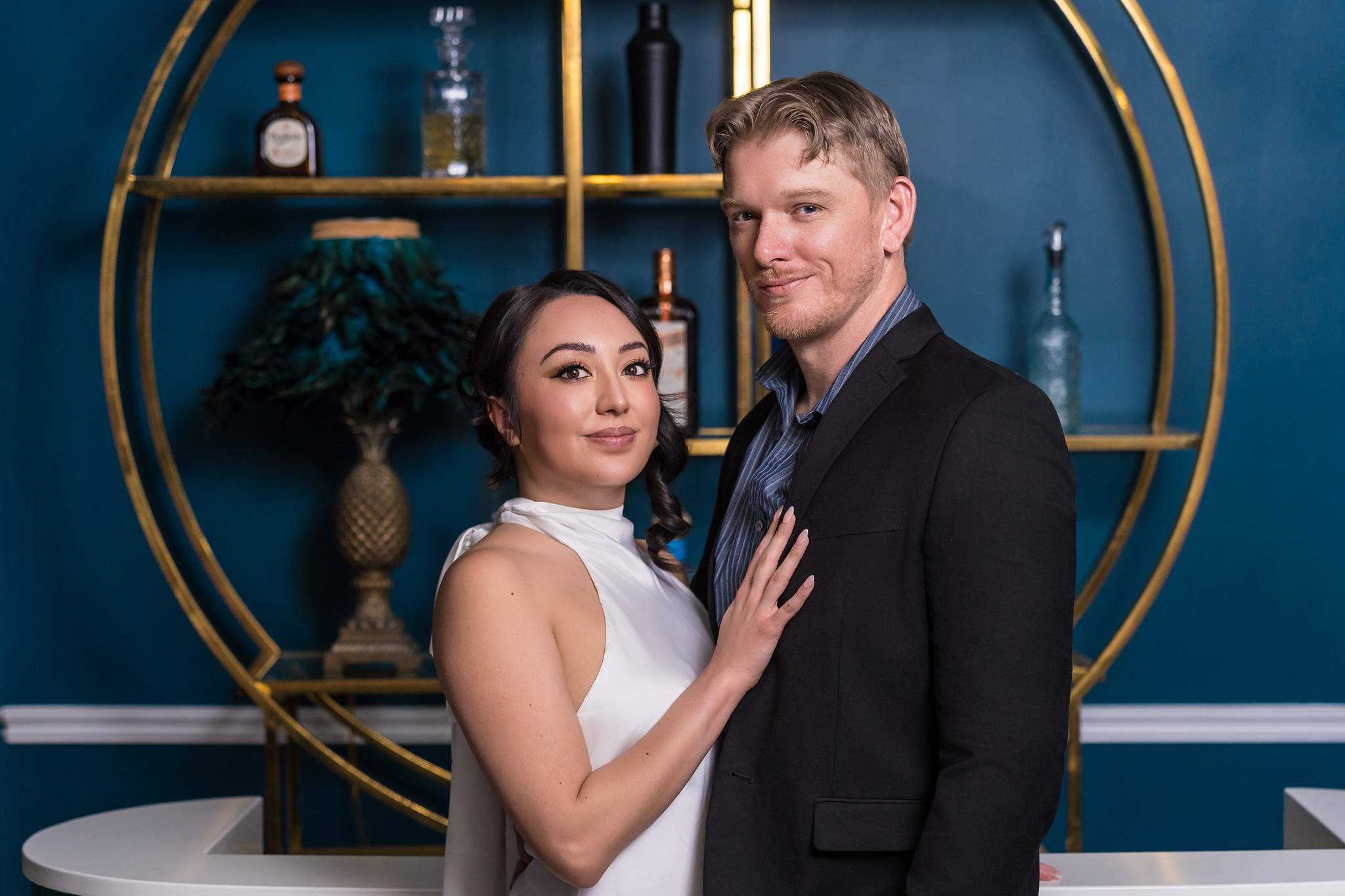 Couple portrait in front of brass shelving at Luxe Galore Studios Atlanta