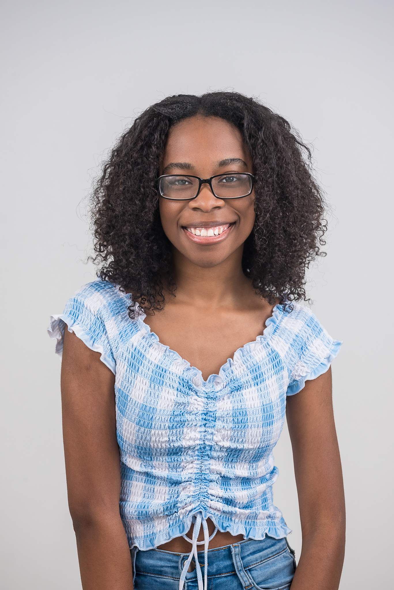 Woman in glasses and a blue gingham top at White Wall Studio Woodstock