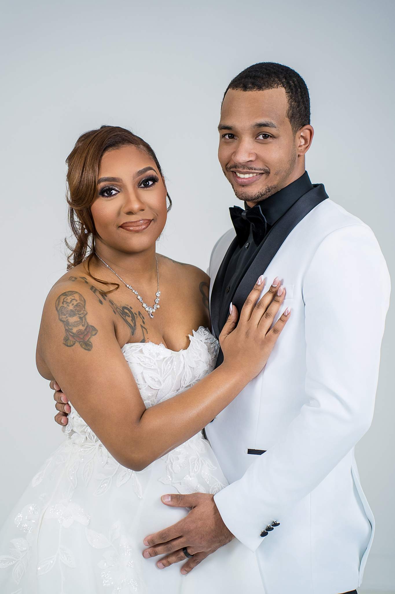 Couple in a white wedding gown and white tuxedo jacket at White Wall Studio Woodstock