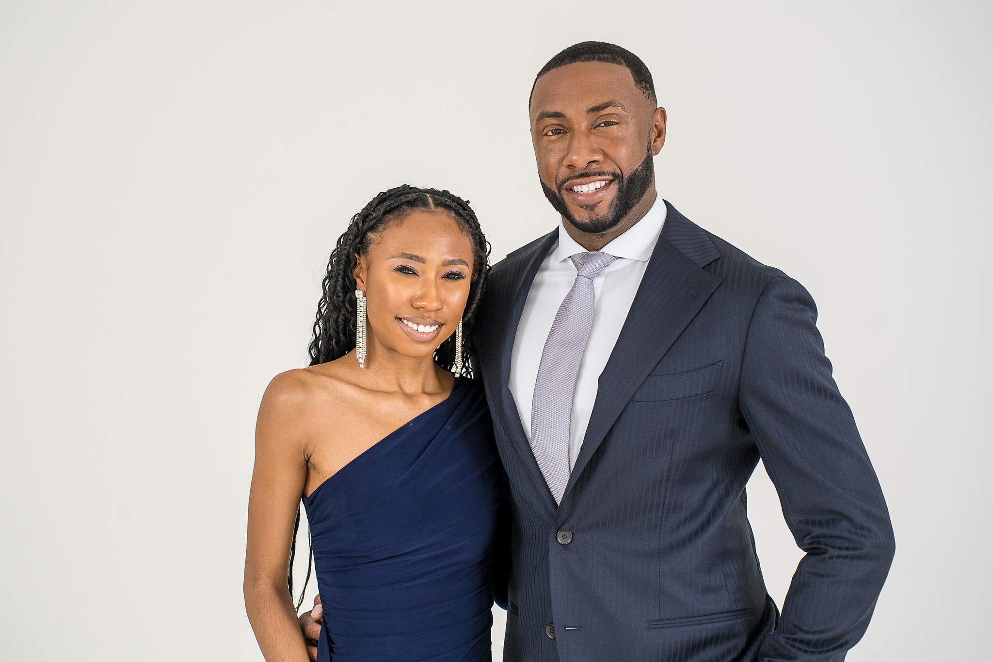 Family members in navy formal wear smiling at White Wall Studio Woodstock