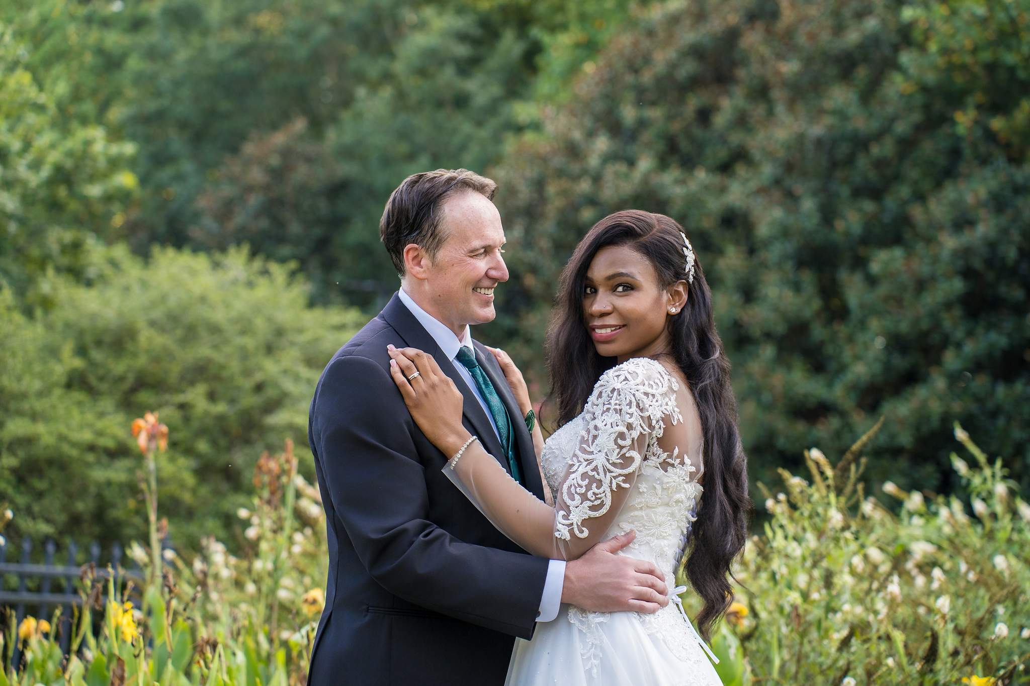 Interracial wedding portrait with the bride’s hand on the groom’s chest