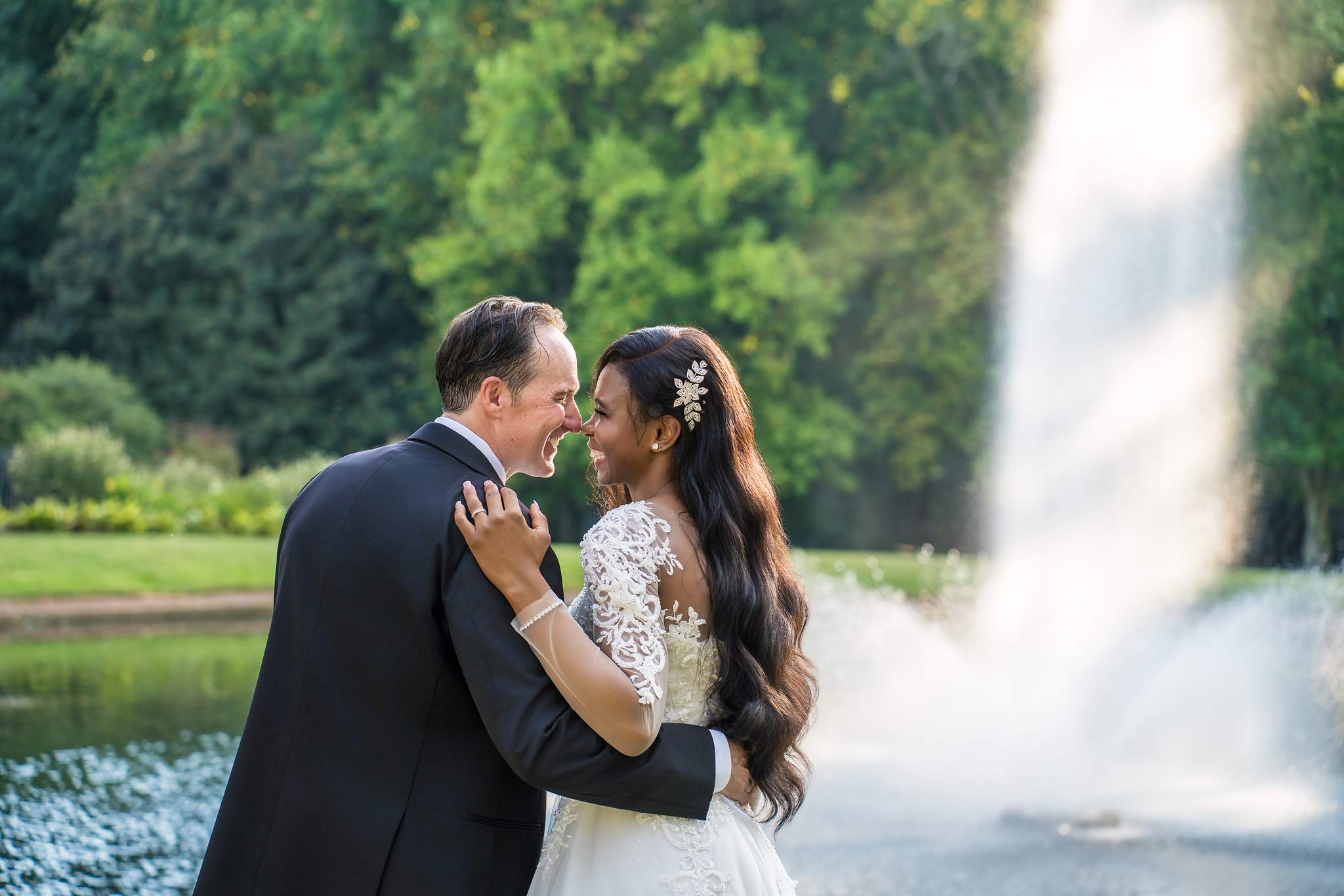 Interracial couple embracing in front of a fountain in Atlanta