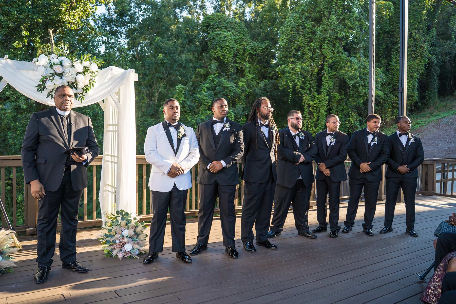 Groom and groomsmen waiting at the ceremony arbor at Ivy Hall at Roswell Mill