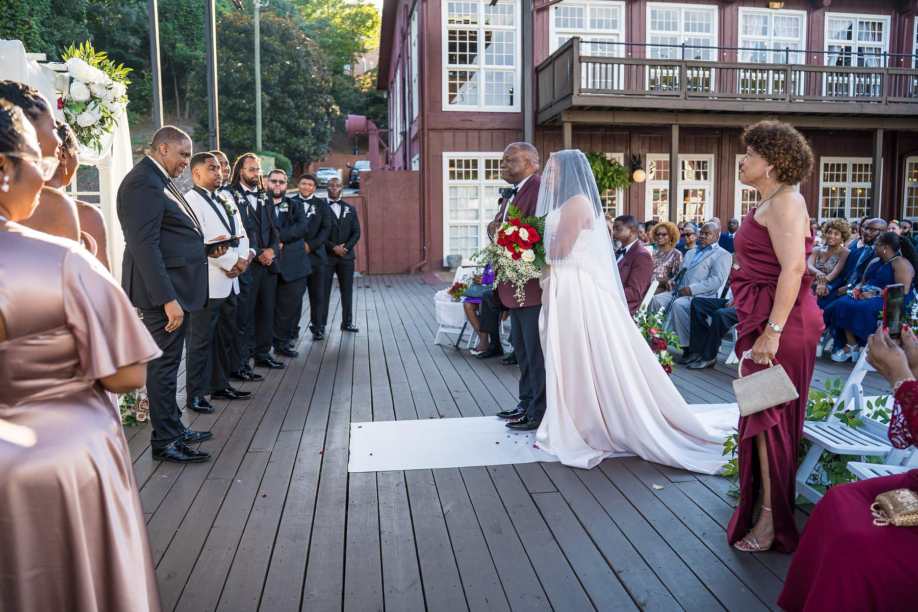 Bride walking down the aisle on the deck at Ivy Hall at Roswell Mill