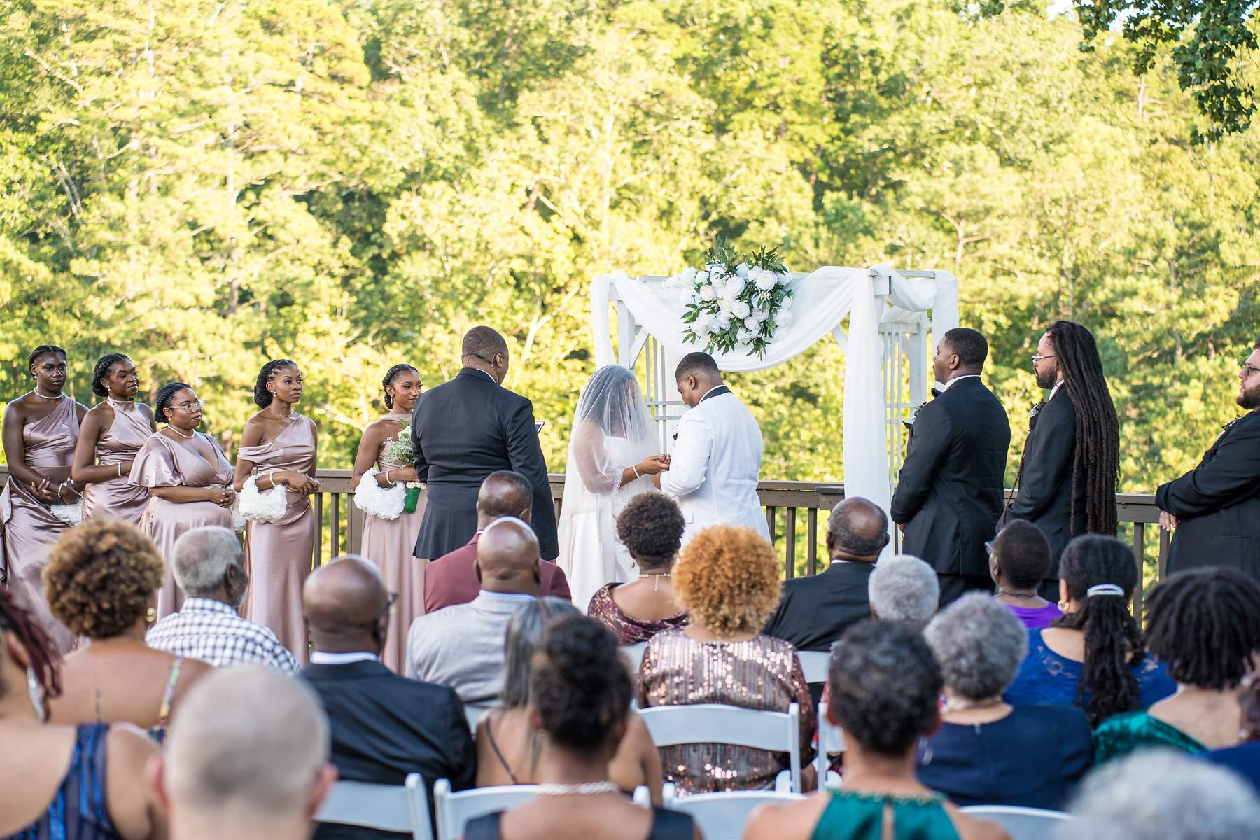 Guests watching an outdoor wedding ceremony on the deck at Ivy Hall at Roswell Mill