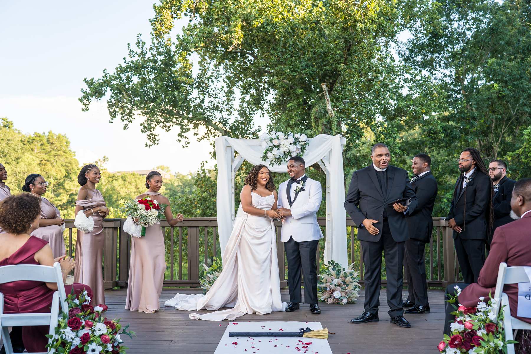 Couple at the arbor with the wedding party during an Ivy Hall at Roswell Mill ceremony