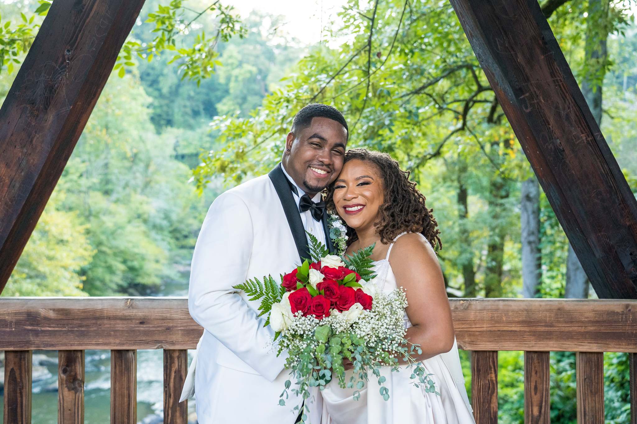 Couple on the covered bridge at Old Mill Park near Ivy Hall at Roswell Mill