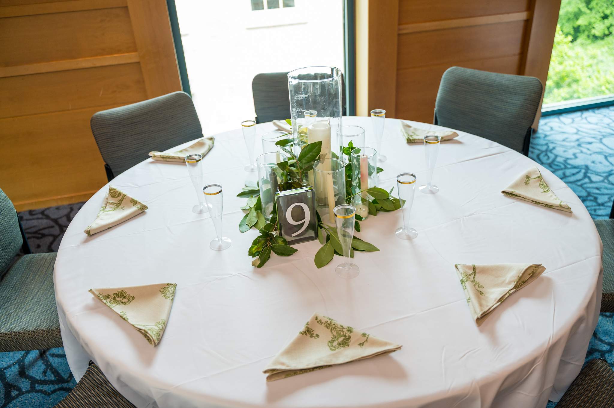 Reception table with greenery and candles in Ackerman Hall
