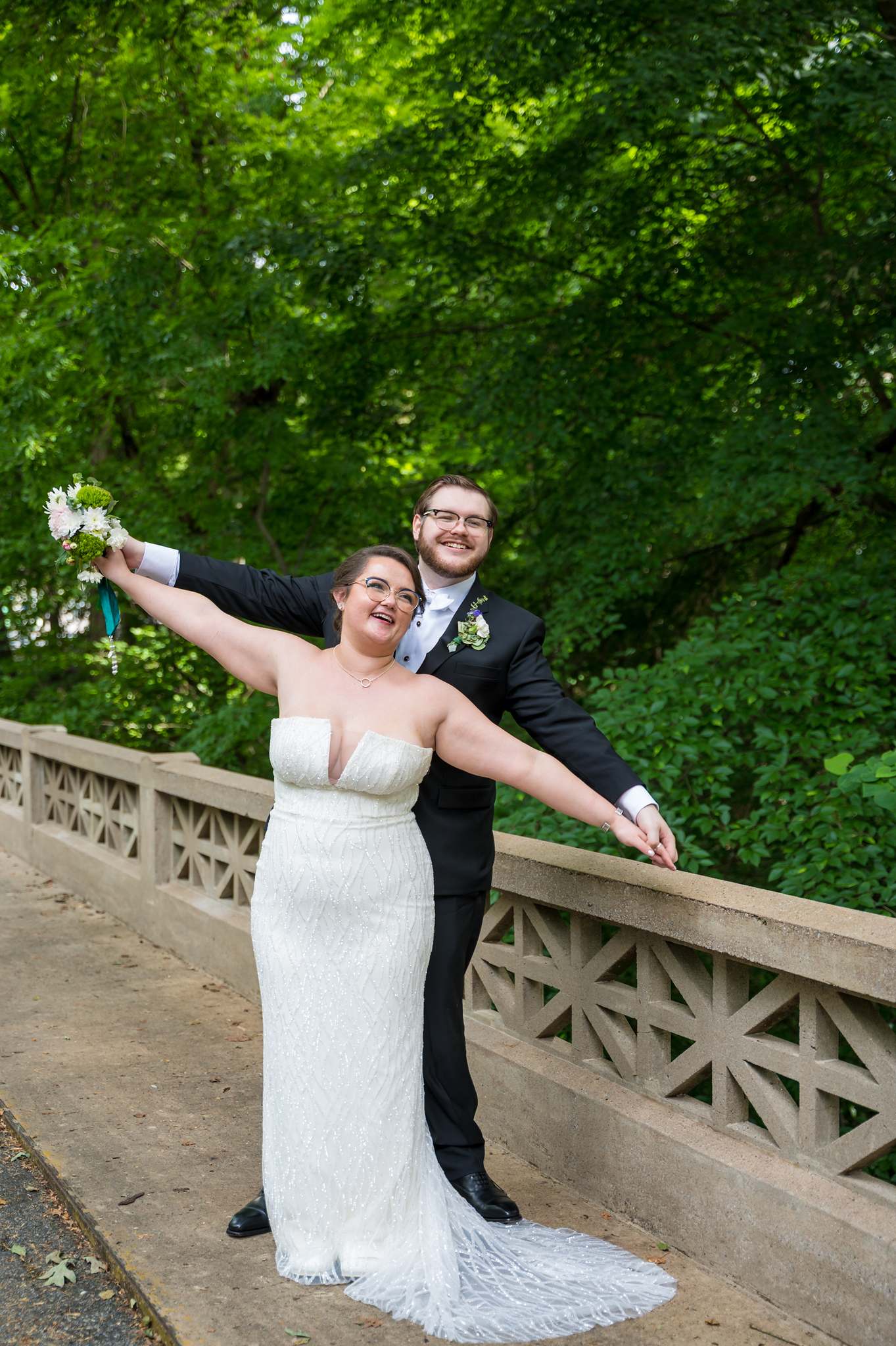 Couple celebrating on a stone bridge near the Michael C. Carlos Museum