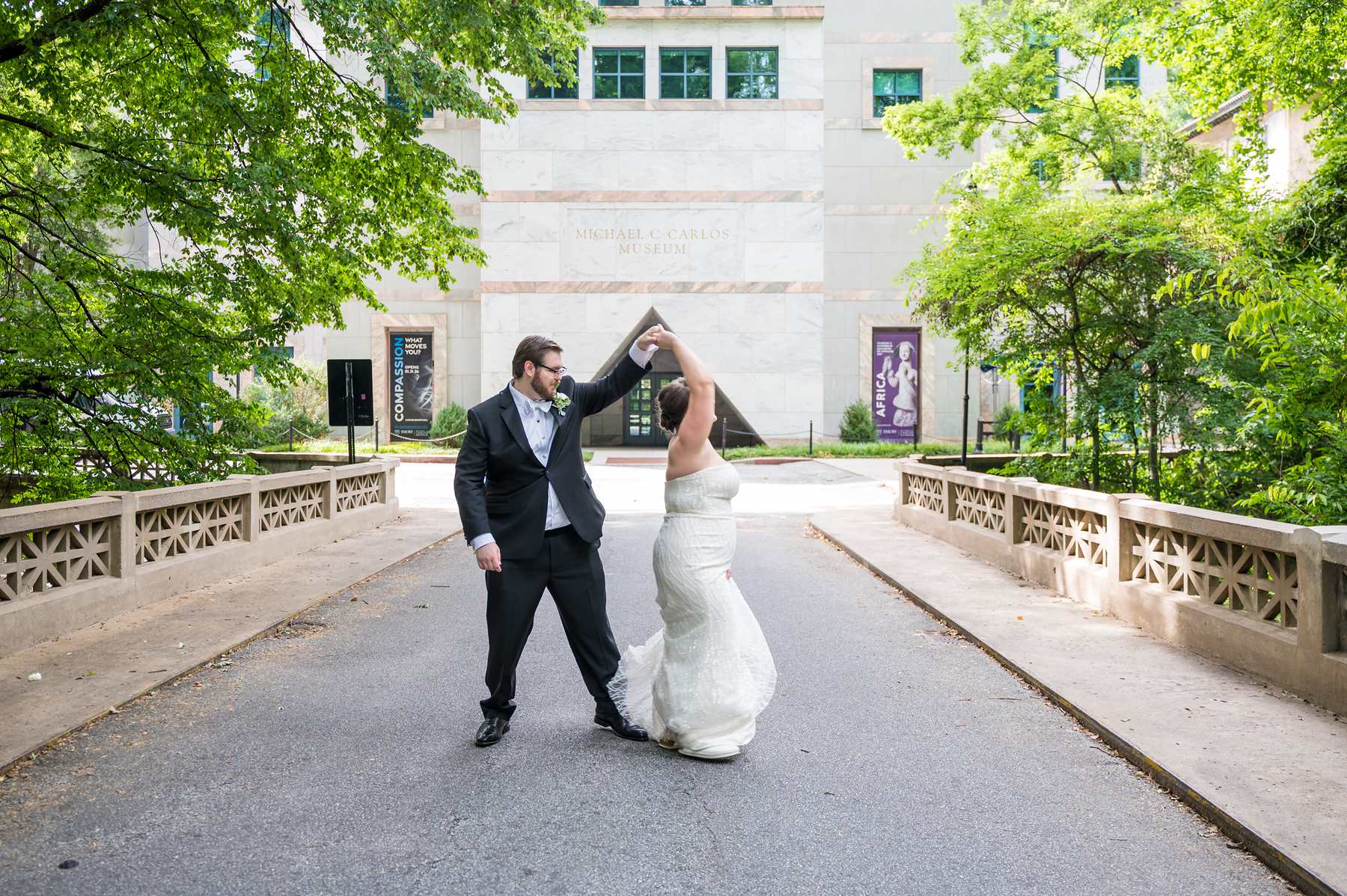 Couple dancing on the bridge with the museum behind them