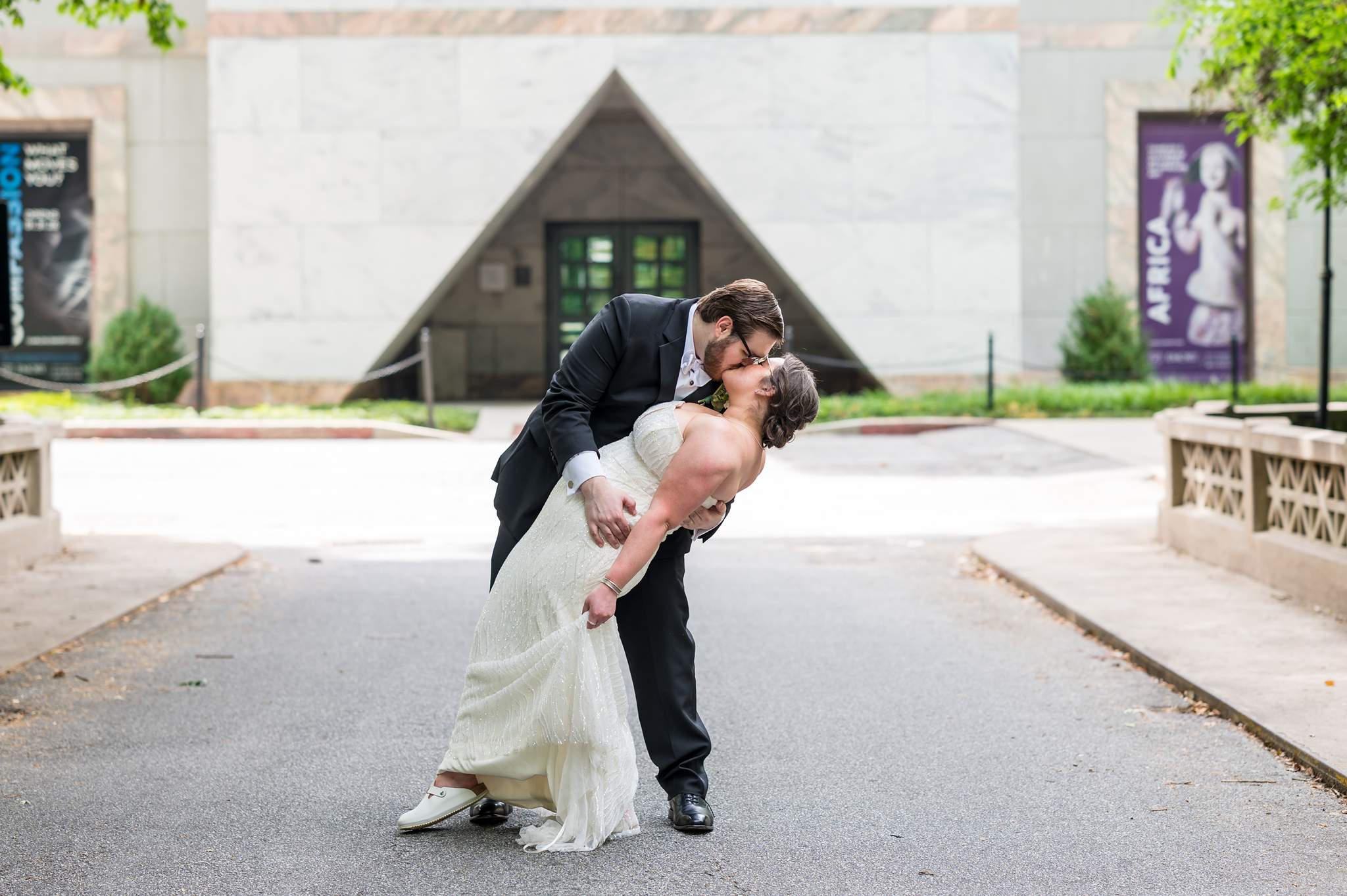 Groom dipping the bride in front of the Michael C. Carlos Museum