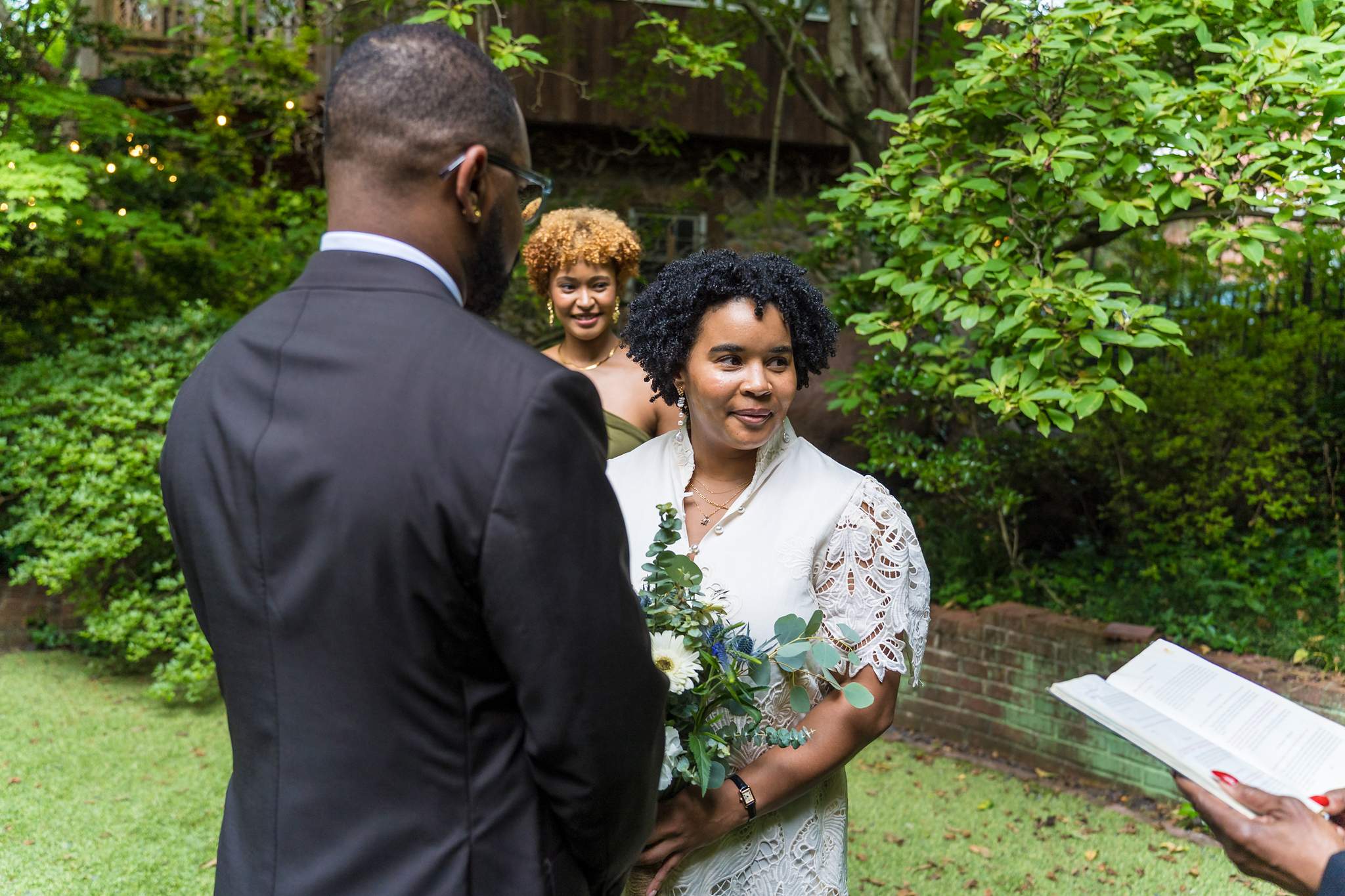 Bride and groom exchanging vows during an intimate garden micro wedding ceremony