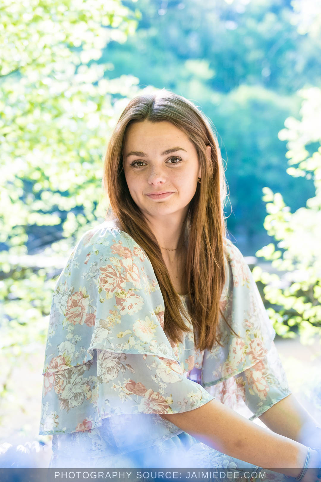 Soft backlit senior portrait along the Little River at Olde Rope Mill Park in Woodstock, GA